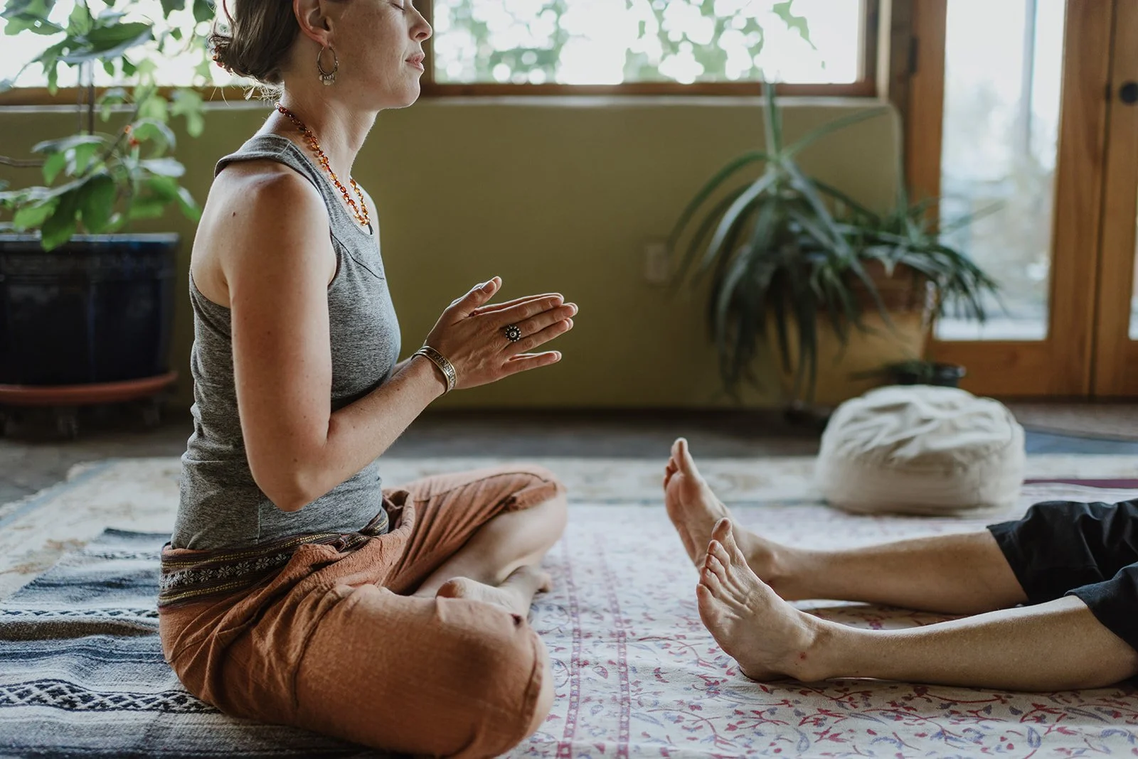 Chanda beginning a Thai Yoga therapy session by touching the feet of the receiver