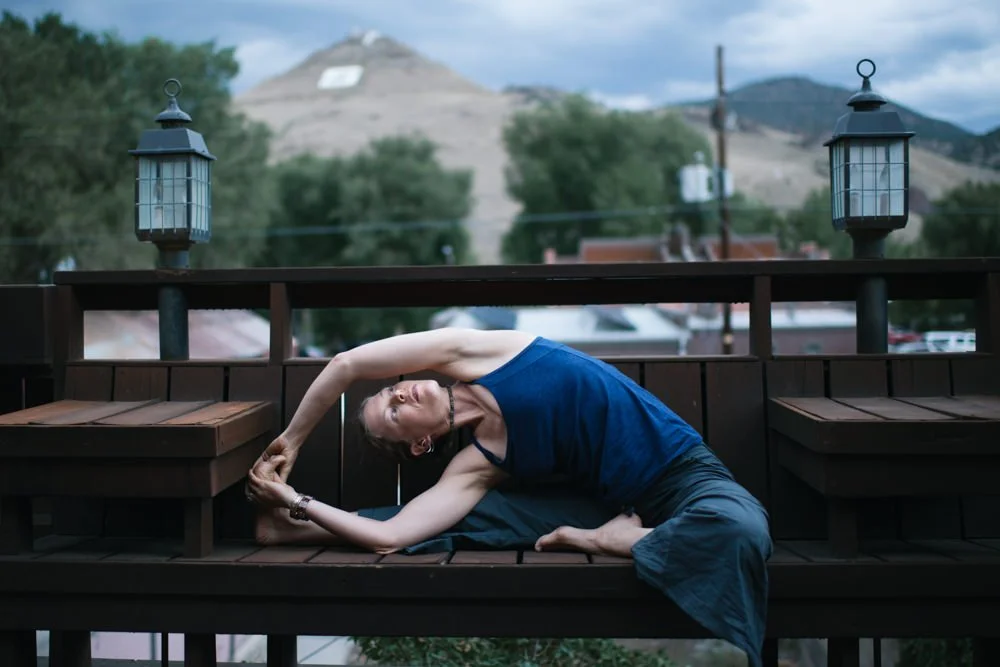 chanda in revolved head to knee pose