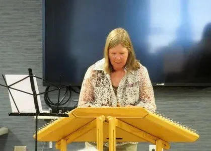 Laurie playing the hammer dulcimer