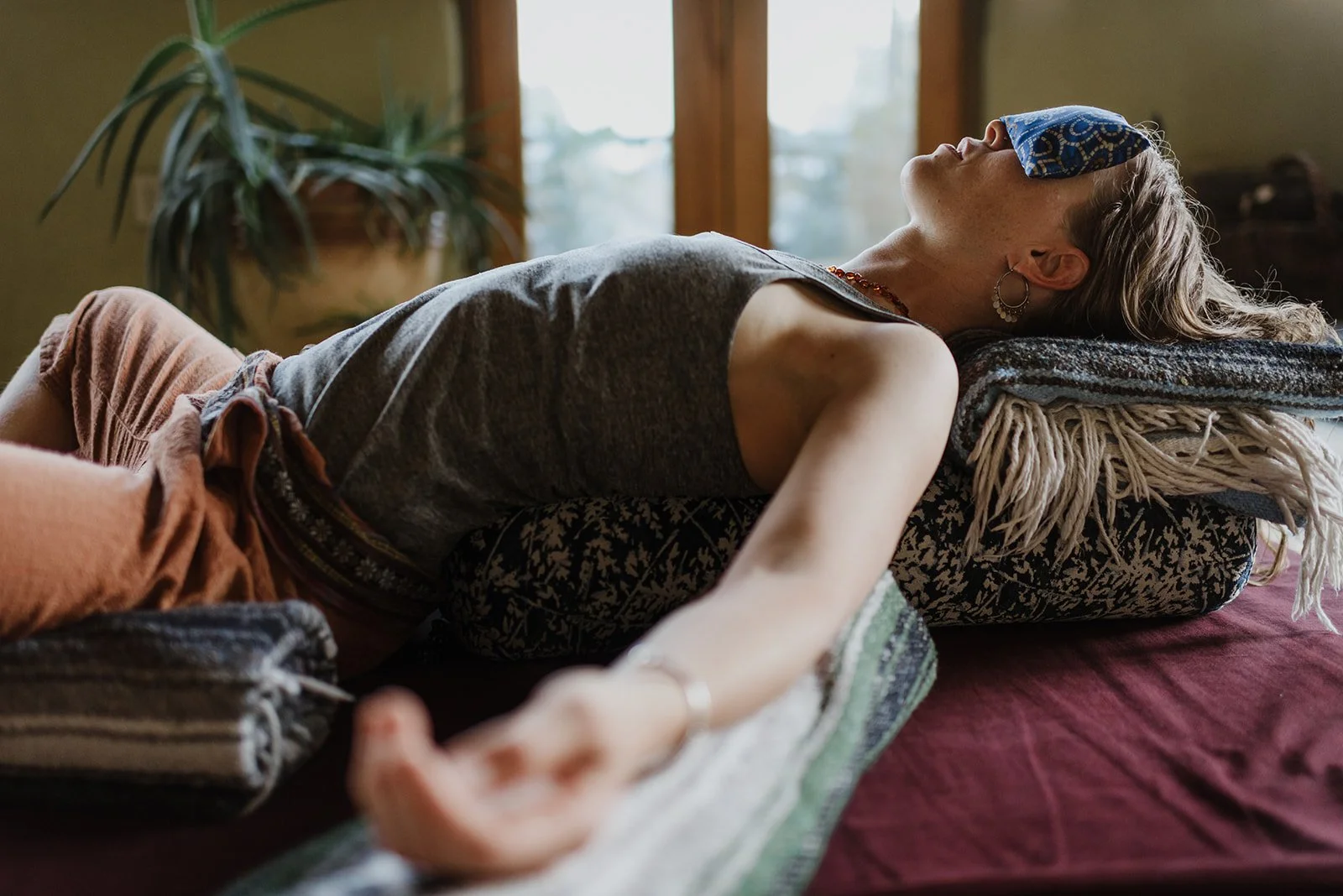 chanda relaxes in a restorative pose