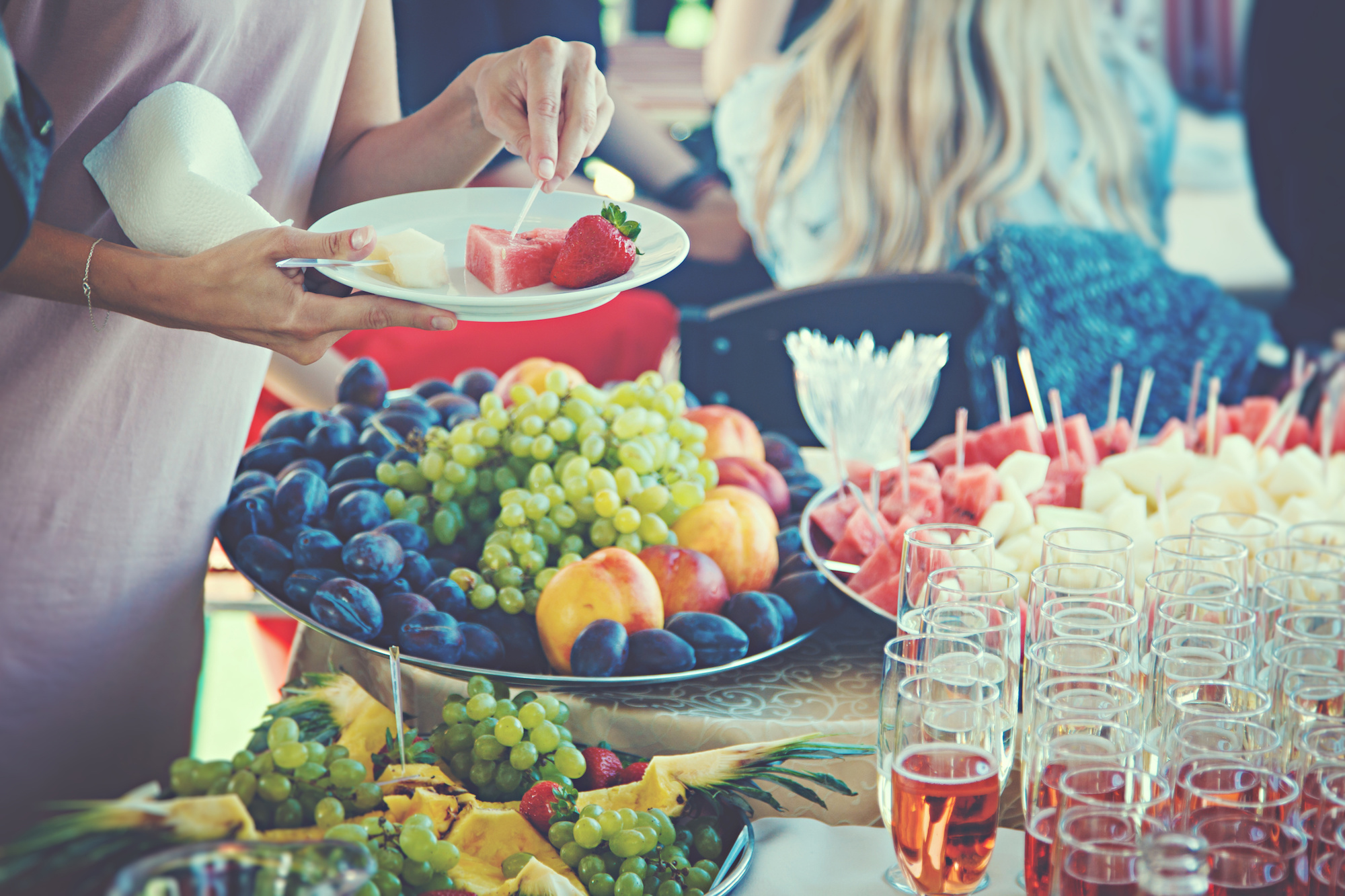 woman choose healthy fruits at buffet.jpeg