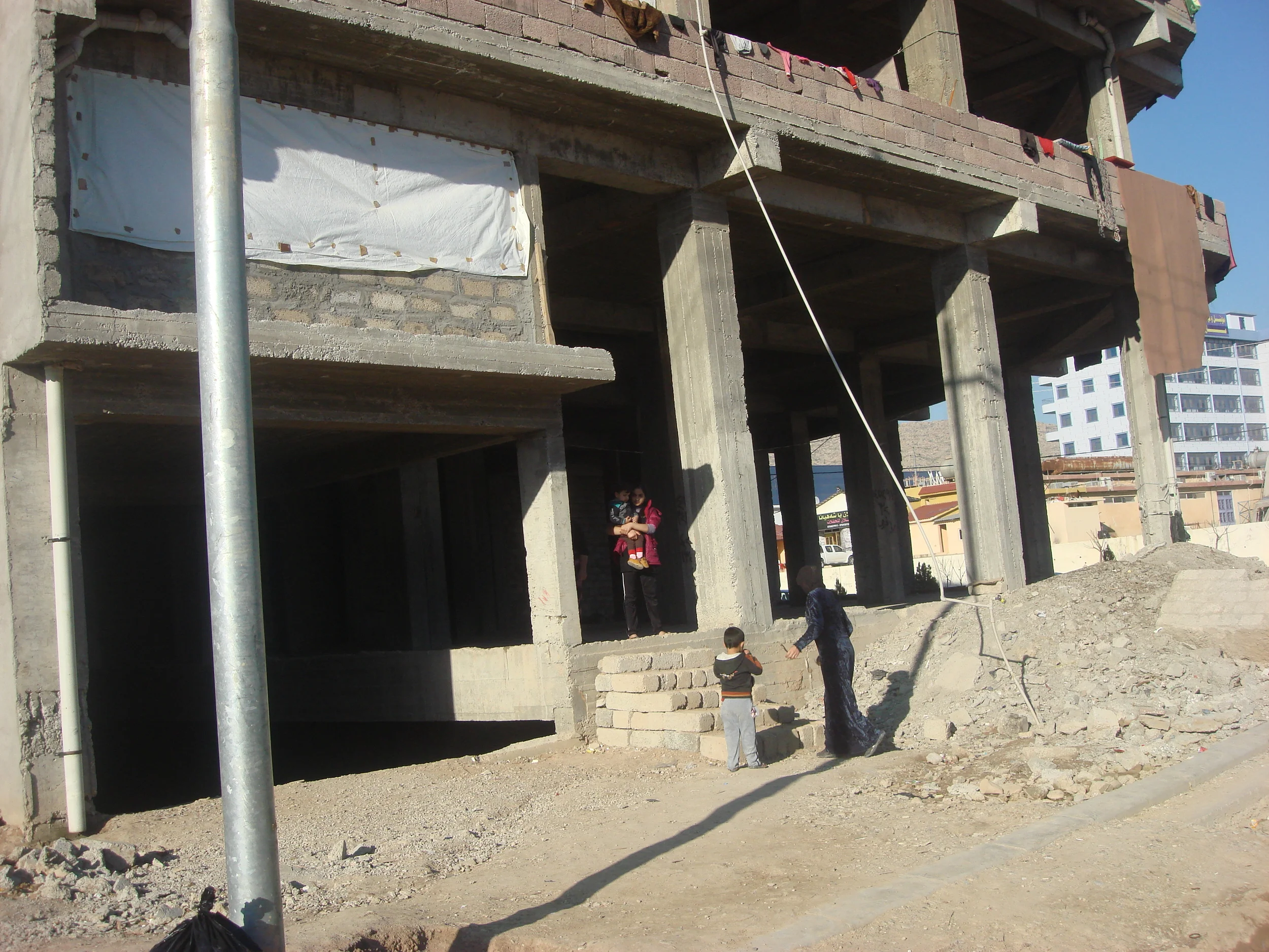 Families have been living in this construction site with young children through freezing winter snow