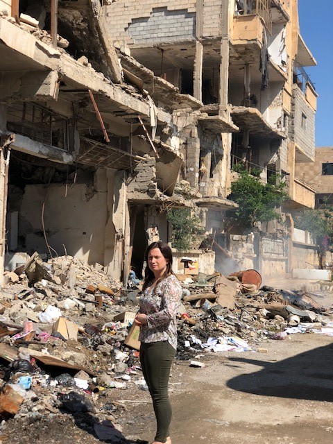 Samara in street next to Al Rahmie Medical Centre. Much of the local area has been destroyed, yet many people are living in the ruins.