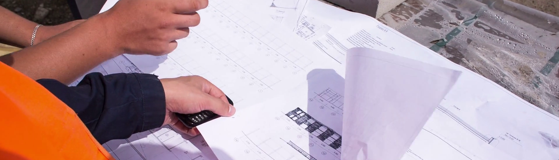 building-plan-lying-on-the-bricks-engineers-and-construction-workers-studying-drawing-close-up_nd9vft3ul_thumbnail-full01.png