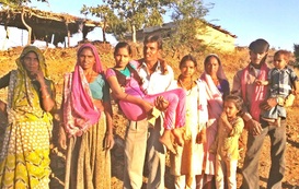  Kapila being carried by her dad surrounded by her family 