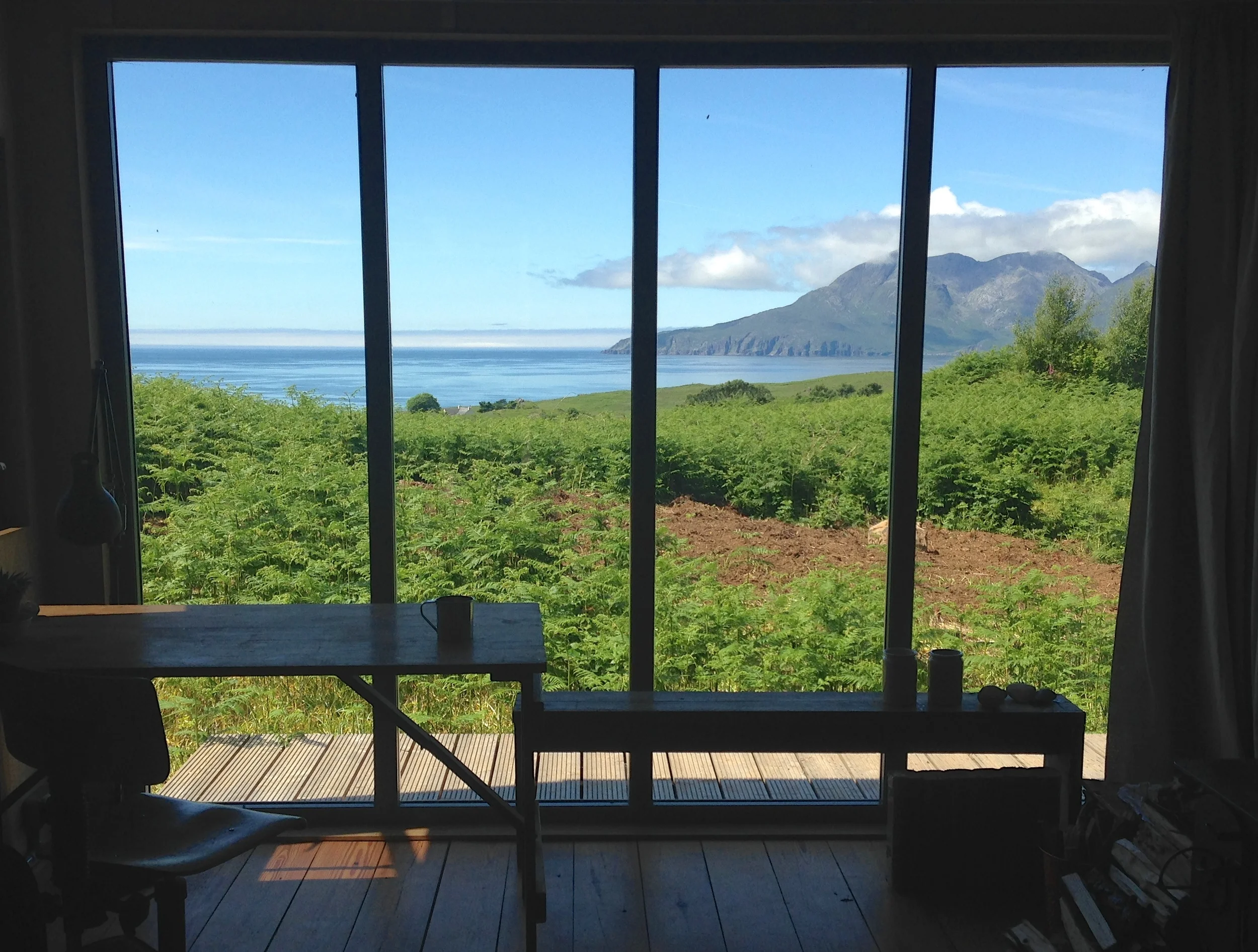 From inside, out. Views (and sunsets) over the Isle of Rum are incredible