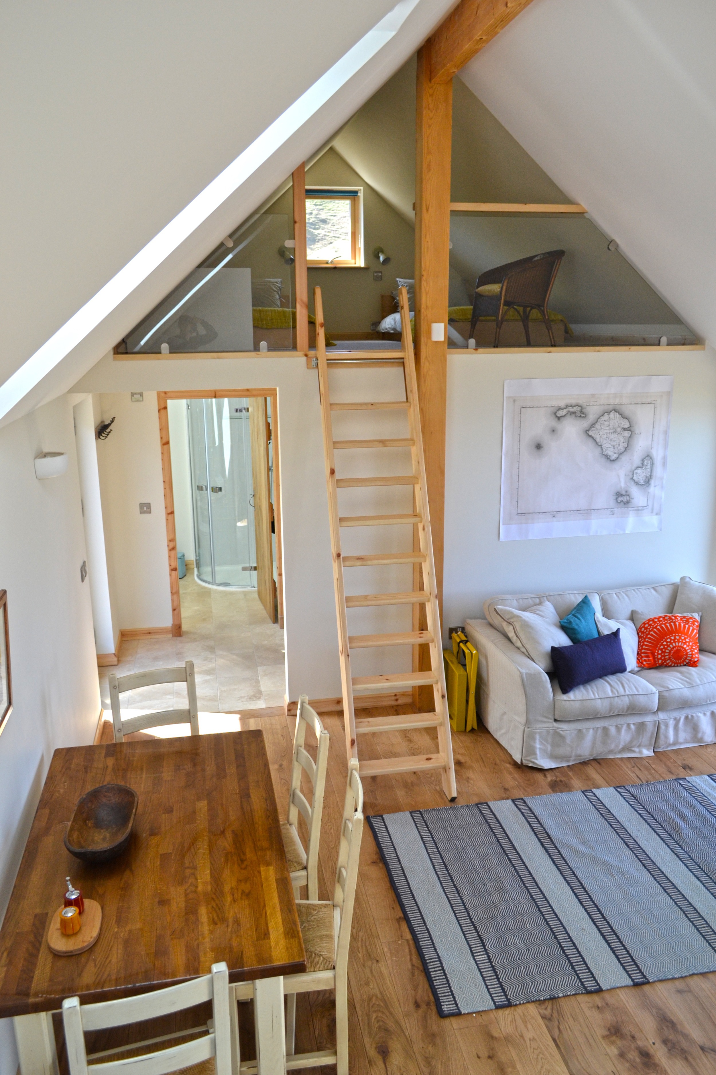 Mezzanine bedroom, accessible by fold away ladder.  Bathroom & double bedroom beyond.