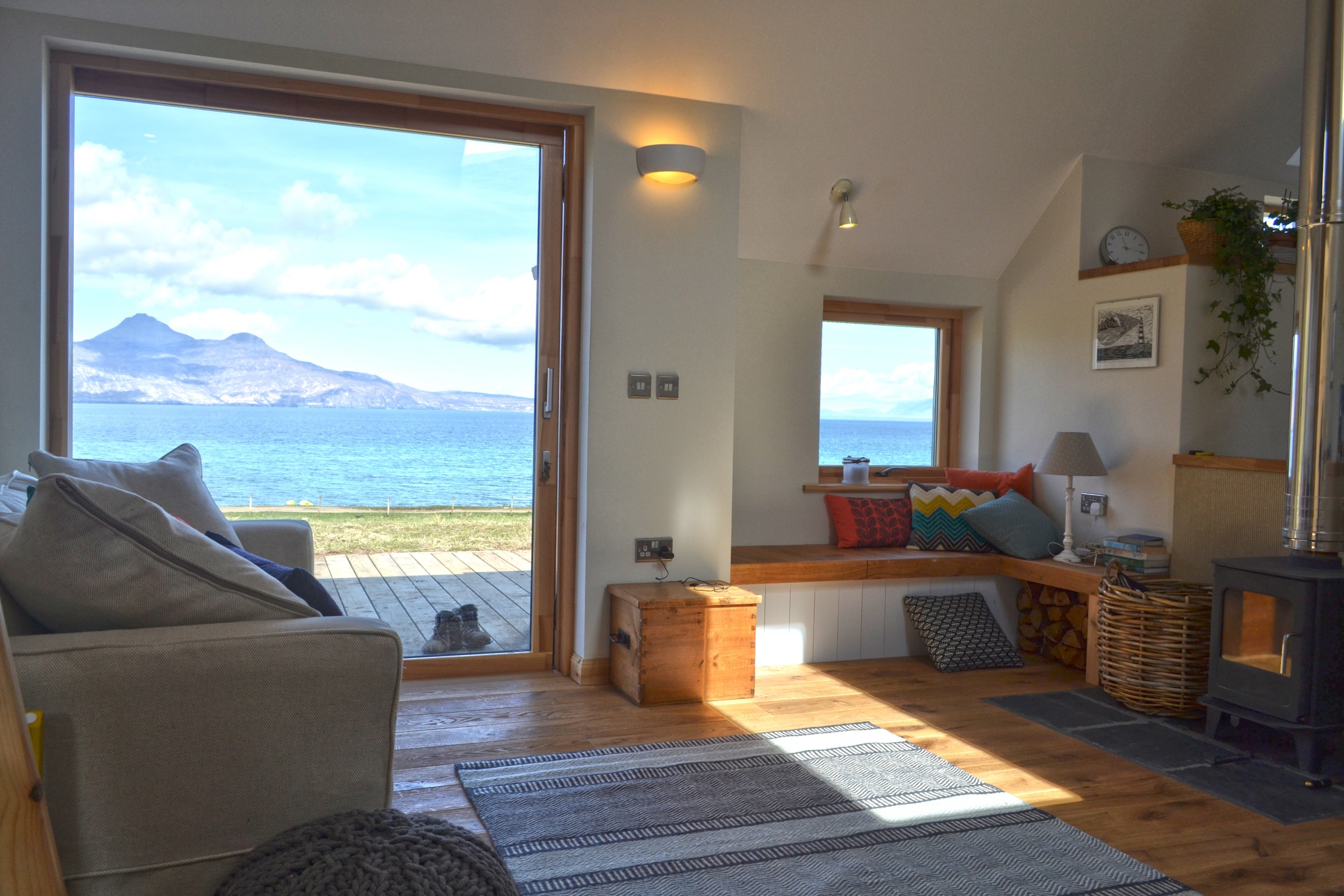 Living room with views from sliding door out to Isle of Rum