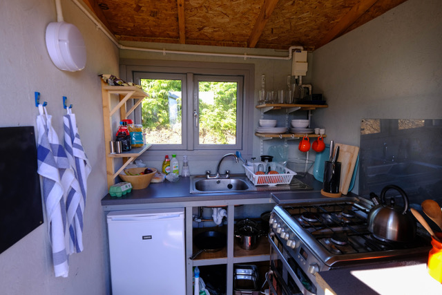 Kitchen, with fridge and full size cooker, has all the pots, pans and other equipment you need to cook.