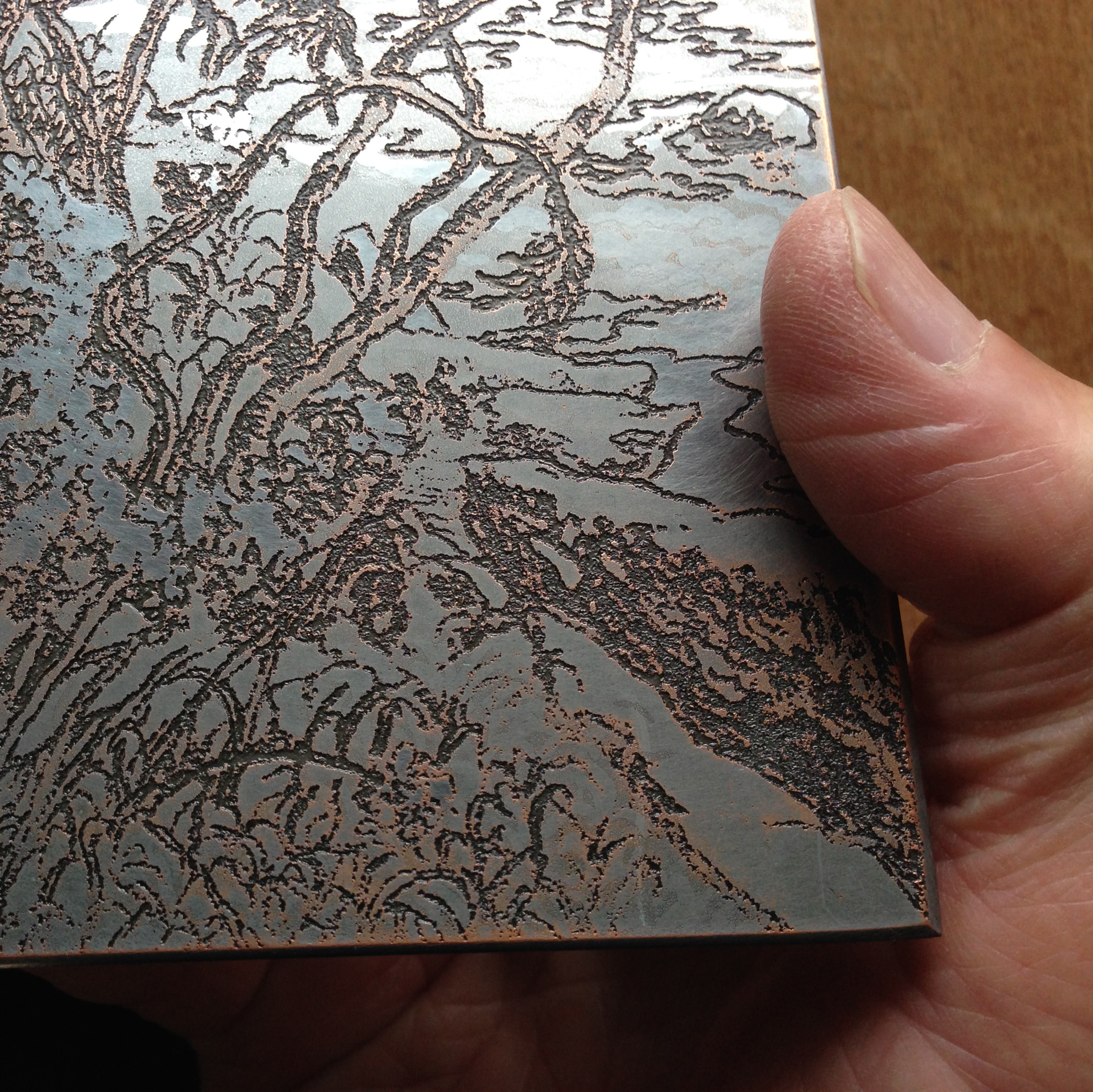 A close-up view shows the depth of the soft ground etching.