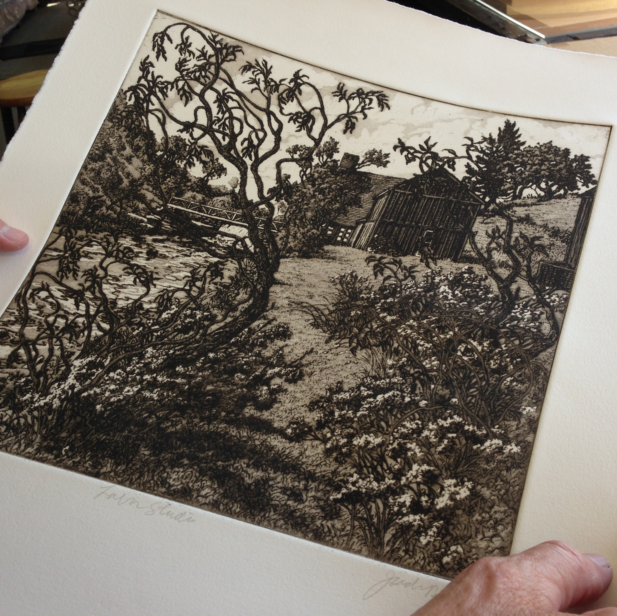 Roger Bailey inspects a print to be sure it has not been over or under wiped. This was one of the more difficult prints in Jack's "Experimental Suite" to ink and wipe with consistency.