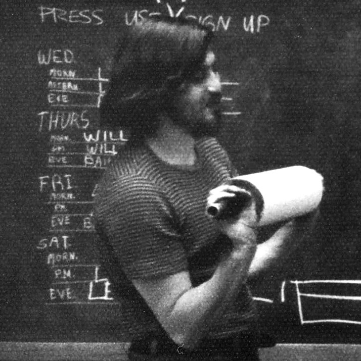  Printer Roger Bailey waits with a freshly charged ink roller while the stone is being dampened again, continuing to re-ink the stone before pulling the next impression.