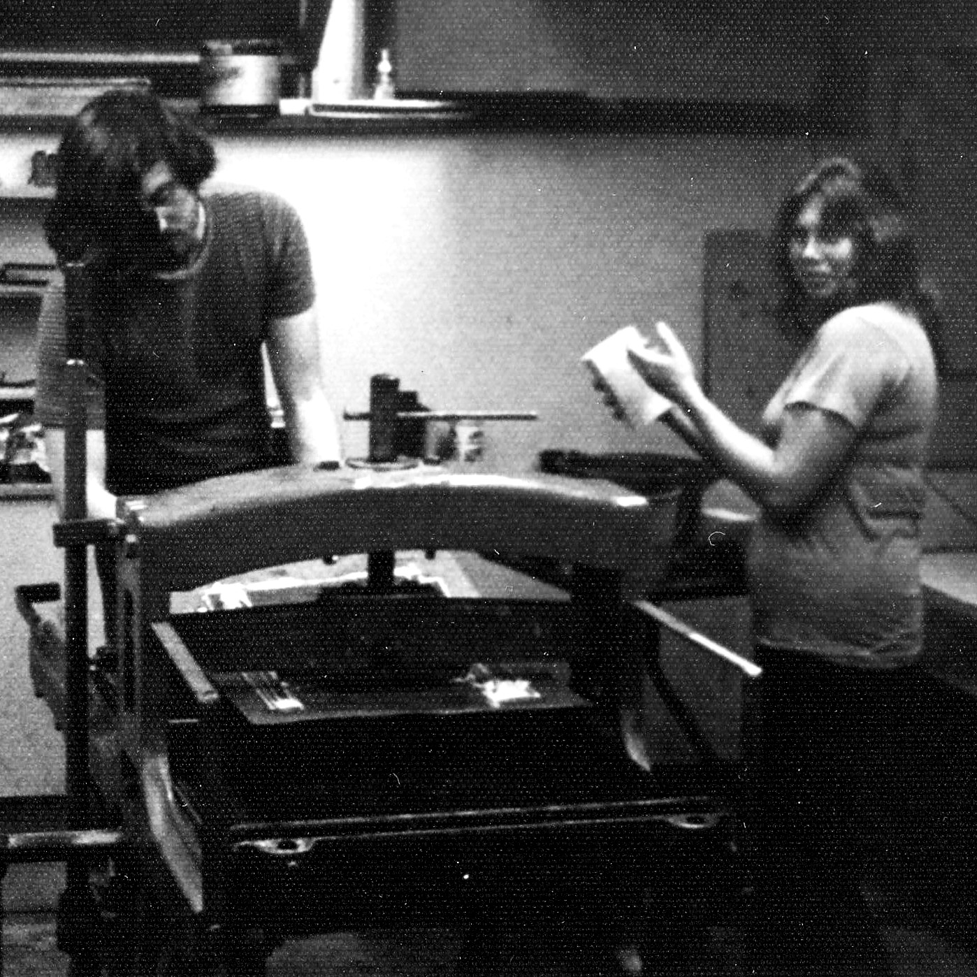 Working in the print room at St. Lawrence University, printer Roger Bailey prepares to pull an impression while Sondra Freckelton stands by ready to re-dampen the stone.