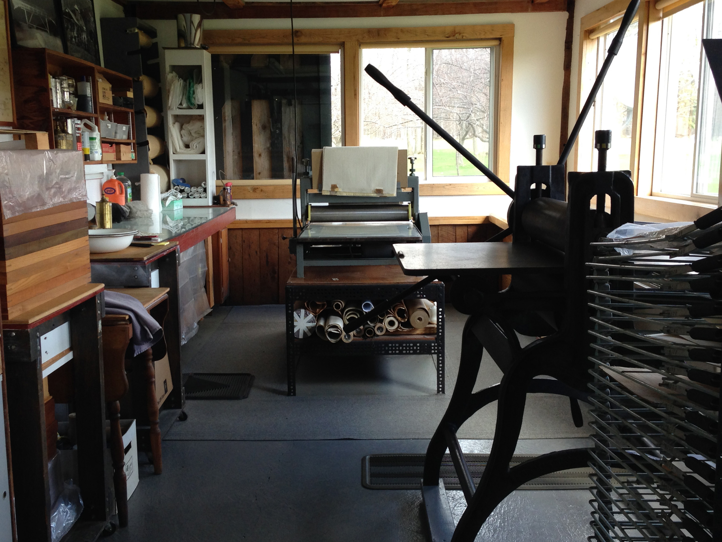 The print studio. A Rembrandt etching press on the right, and a motorized Dickerson combination lithography and etching press in the back. Modest equipment but it does the job.