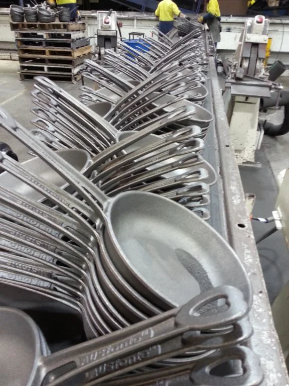They pour fast (up to 800 per hour) and therefore come fast off the shakedown conveyor (where the sand moulds are disintegrated for reclamation and the pans removed from their trees). Now the hard work begins......