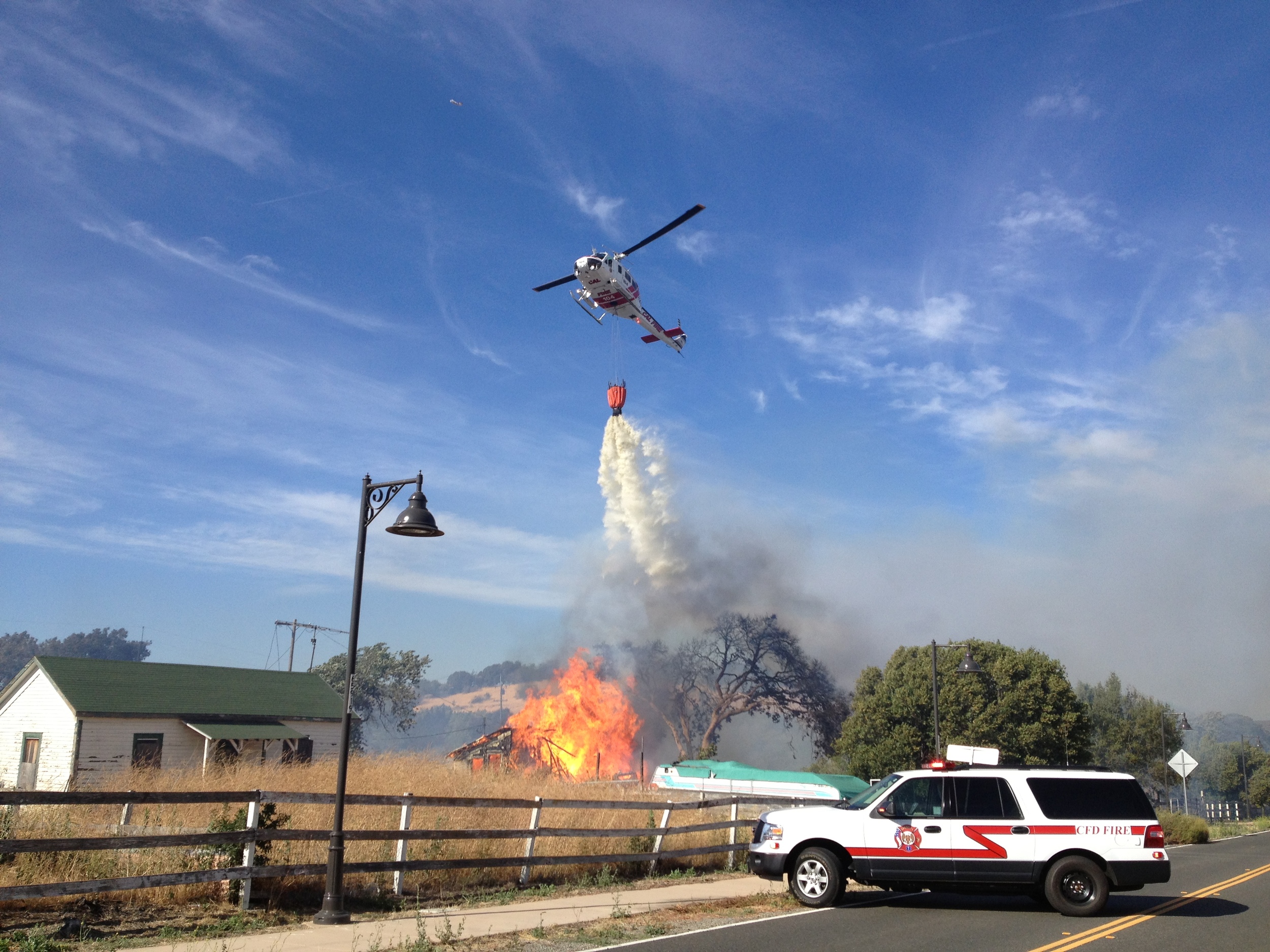iPhone photo of CalFire helicopter water drop. By the way, it's up to the reporter to get out of the way or be doused.