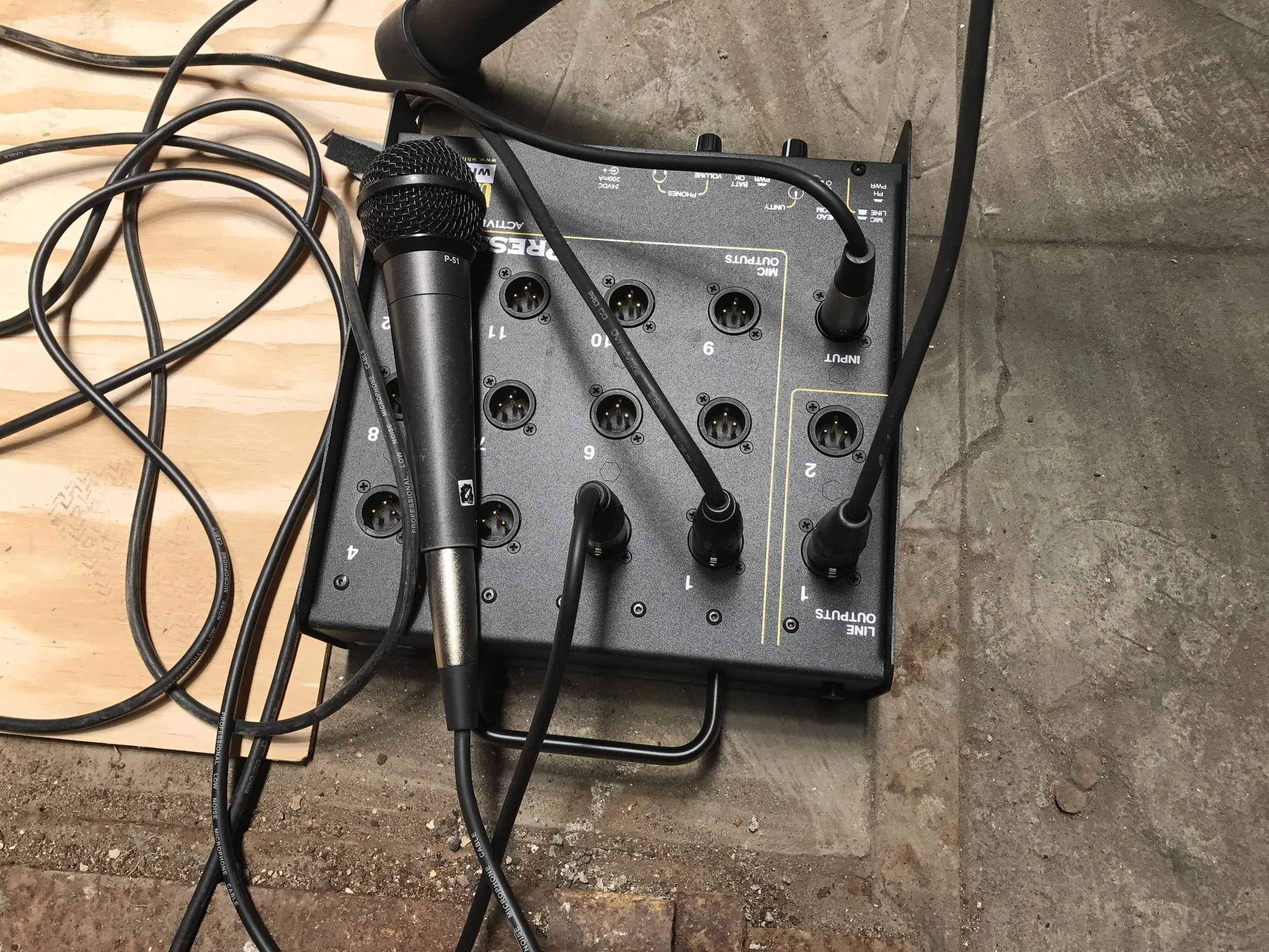 This is a mult box. The microphone cable sends the audio signal into the box and that signal is sent out through all the various outlets so several news teams can record at once.