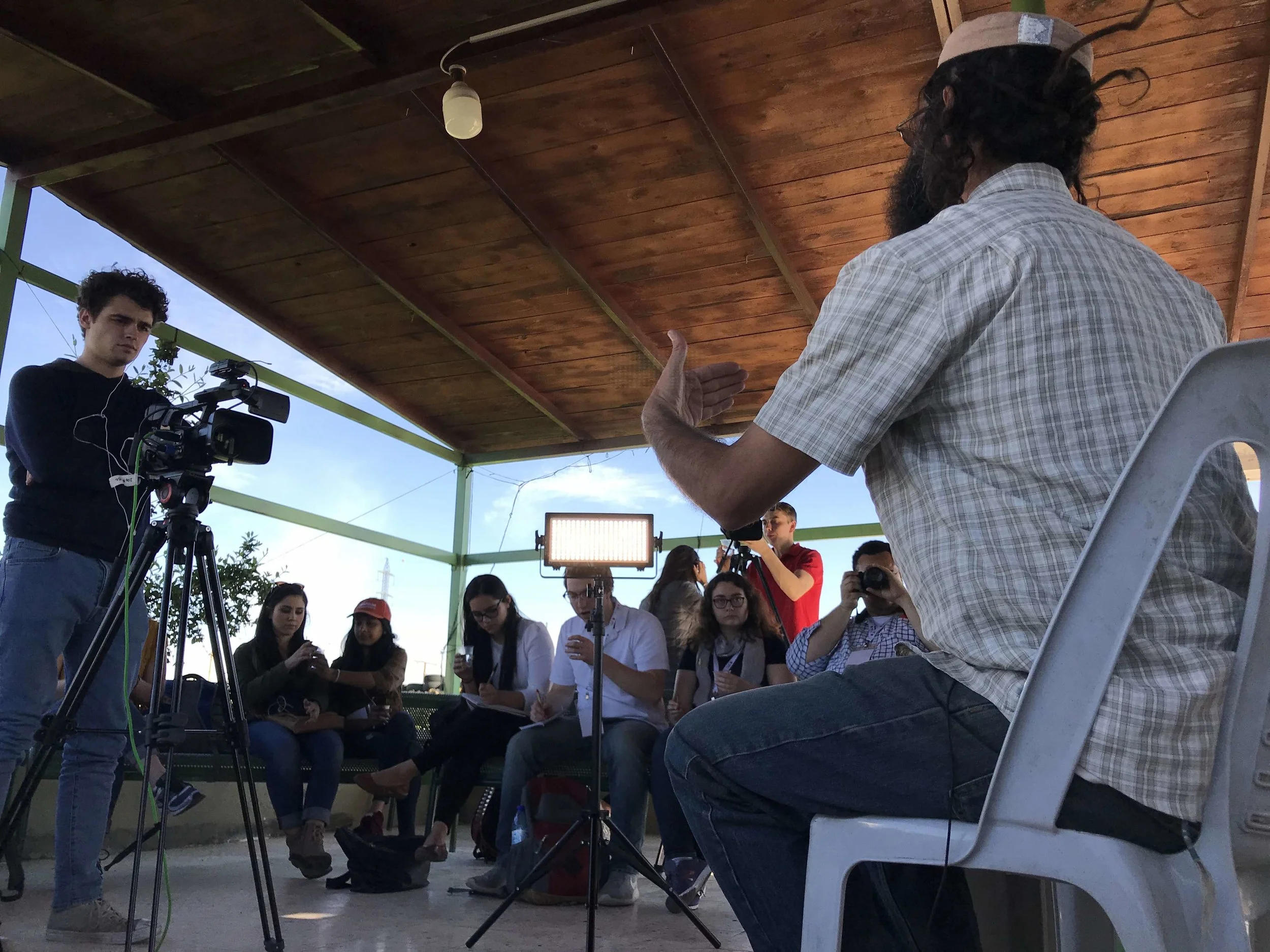 Students interviewing Shaul Judelman, a member of Roots, "a local initiative for understanding, non-violence and transformation."