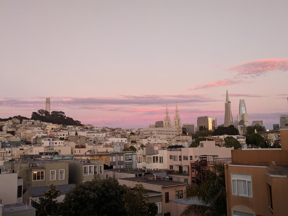  The North Beach neighborhood at dusk with downtown skyscrapers to the right. 