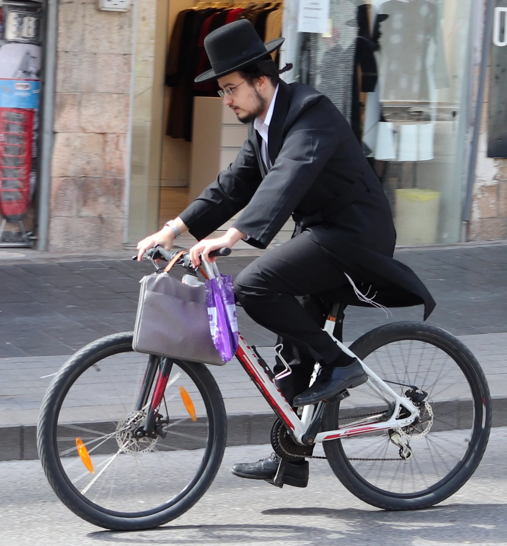Orthodox Jewish man on a bike in Jerusalem.