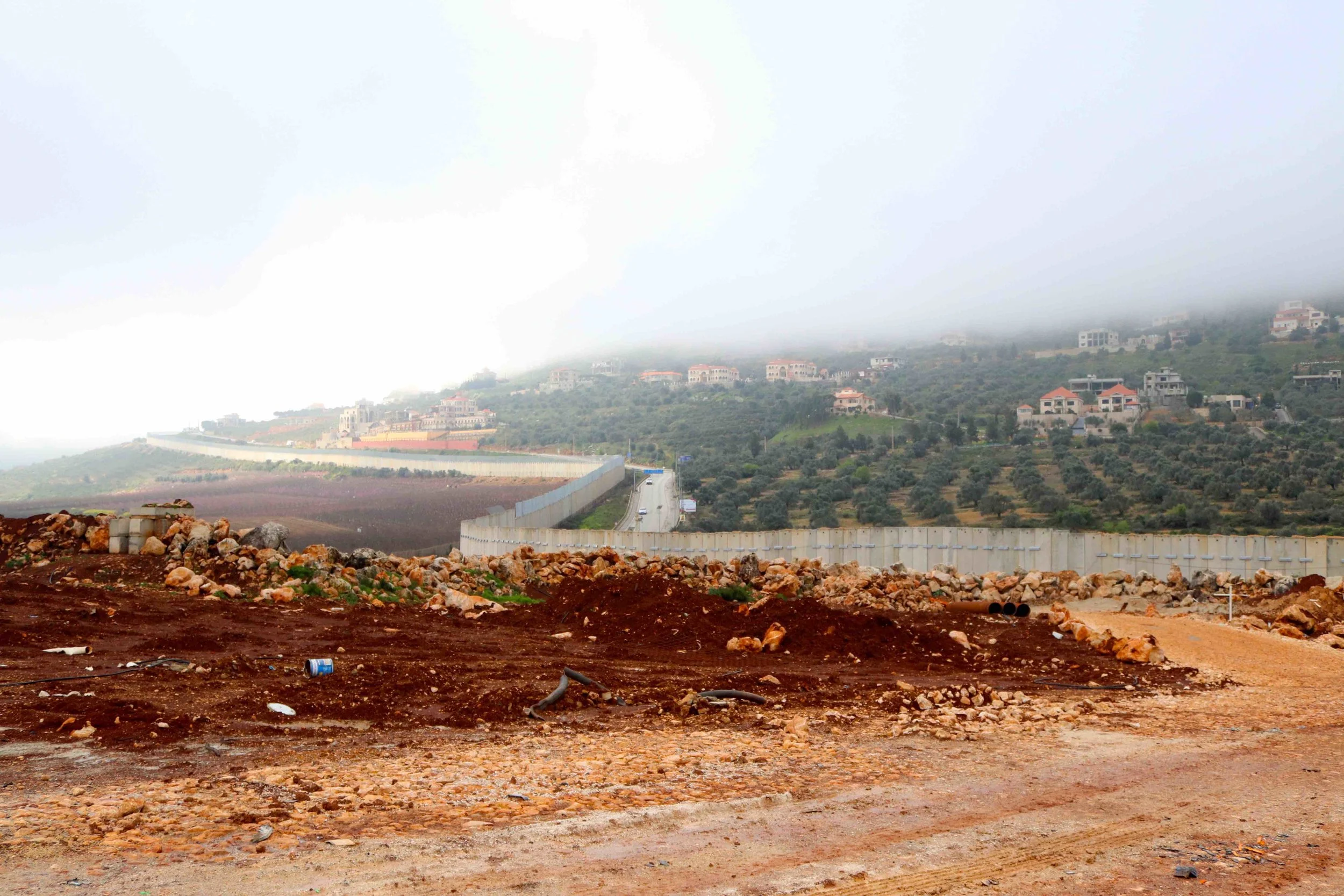 The security wall goes on for miles and miles, criss crossing the landscape.