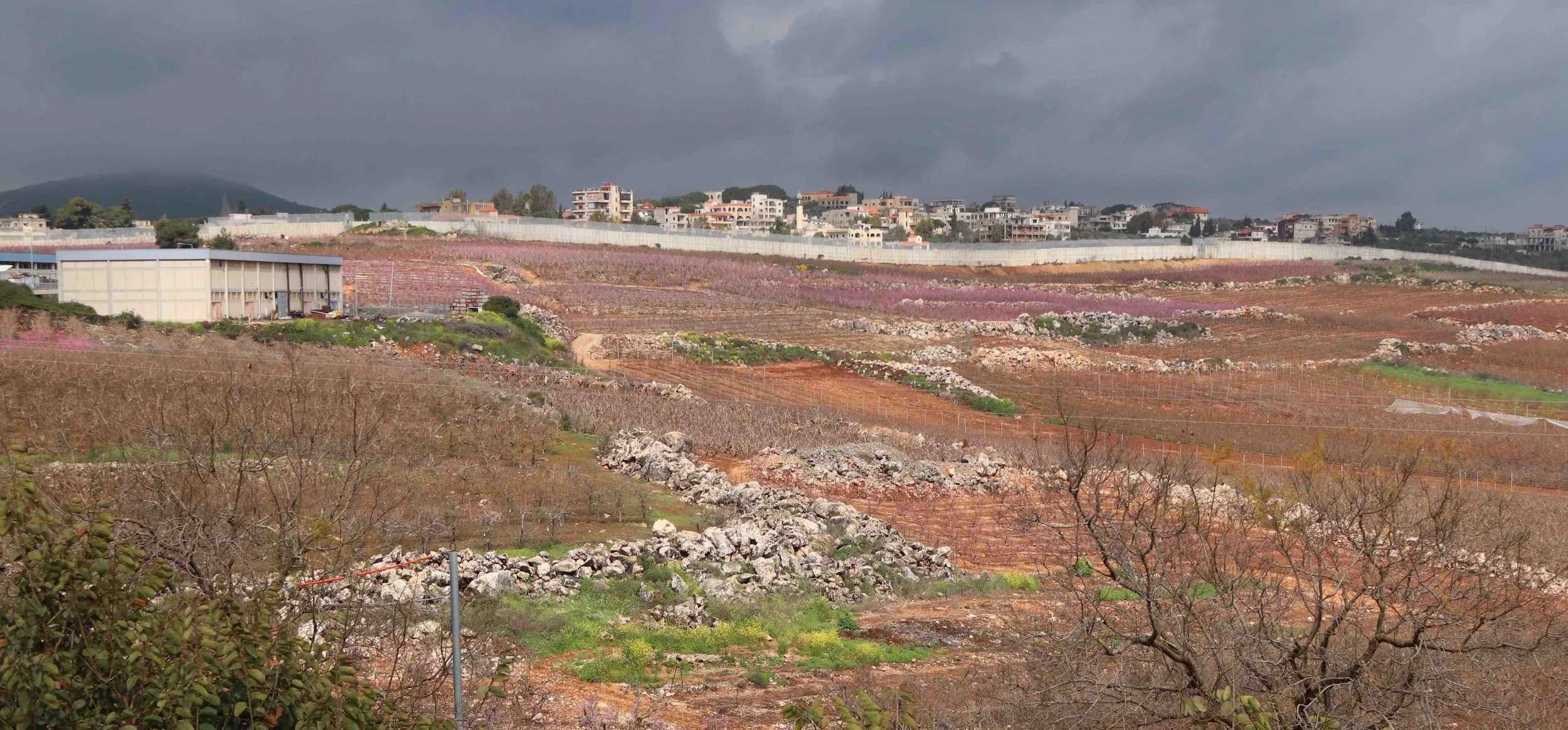 An Israeli security wall separates fertile farmland from sometimes hostile forces in Lebanon.