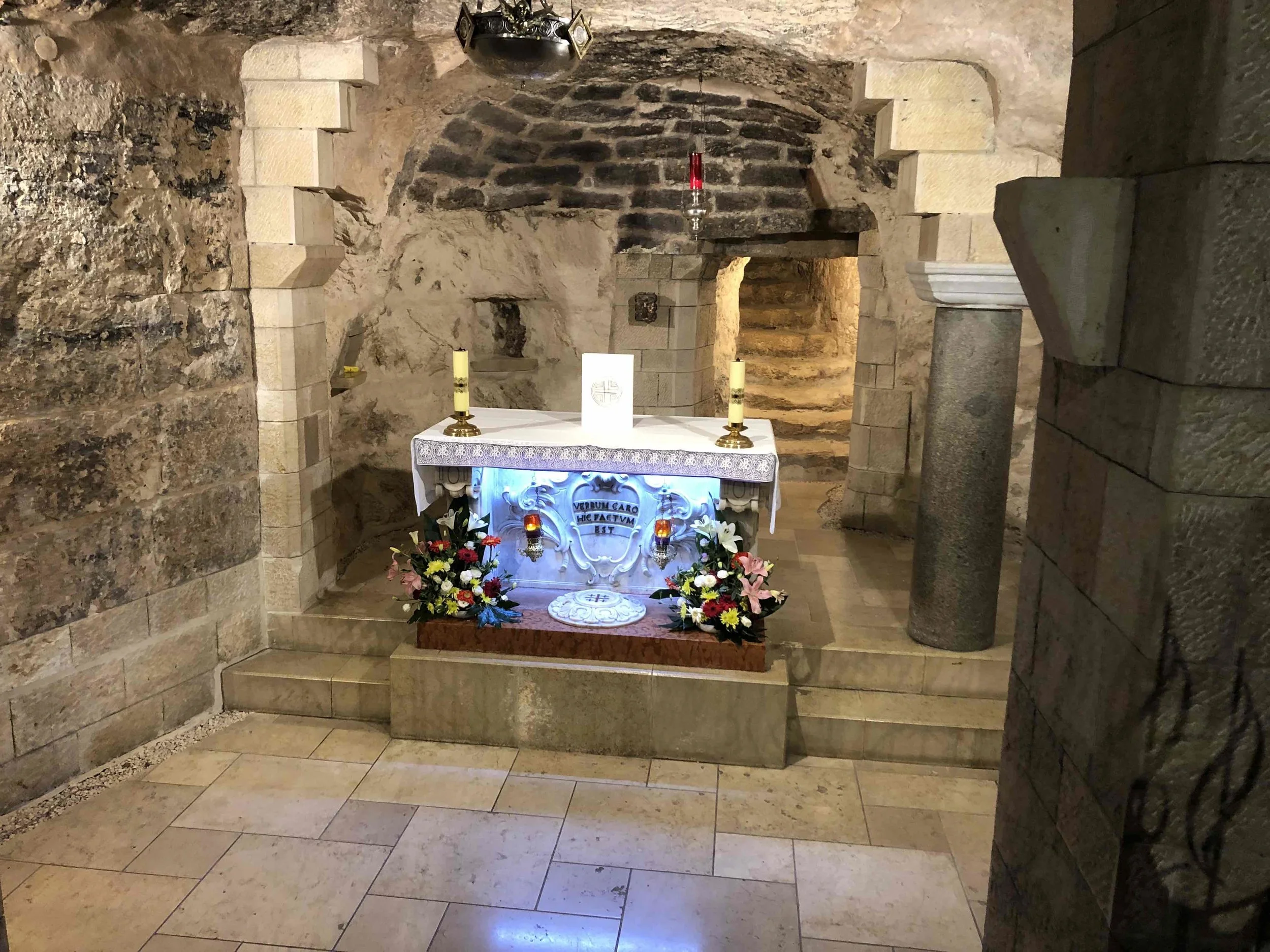At left, the crowds file by the original home of Mary and Joseph. Above, a closer look inside. The first church on this site was built in the 400s. The current church, with modern, towering cupola, was built in the 1960s.