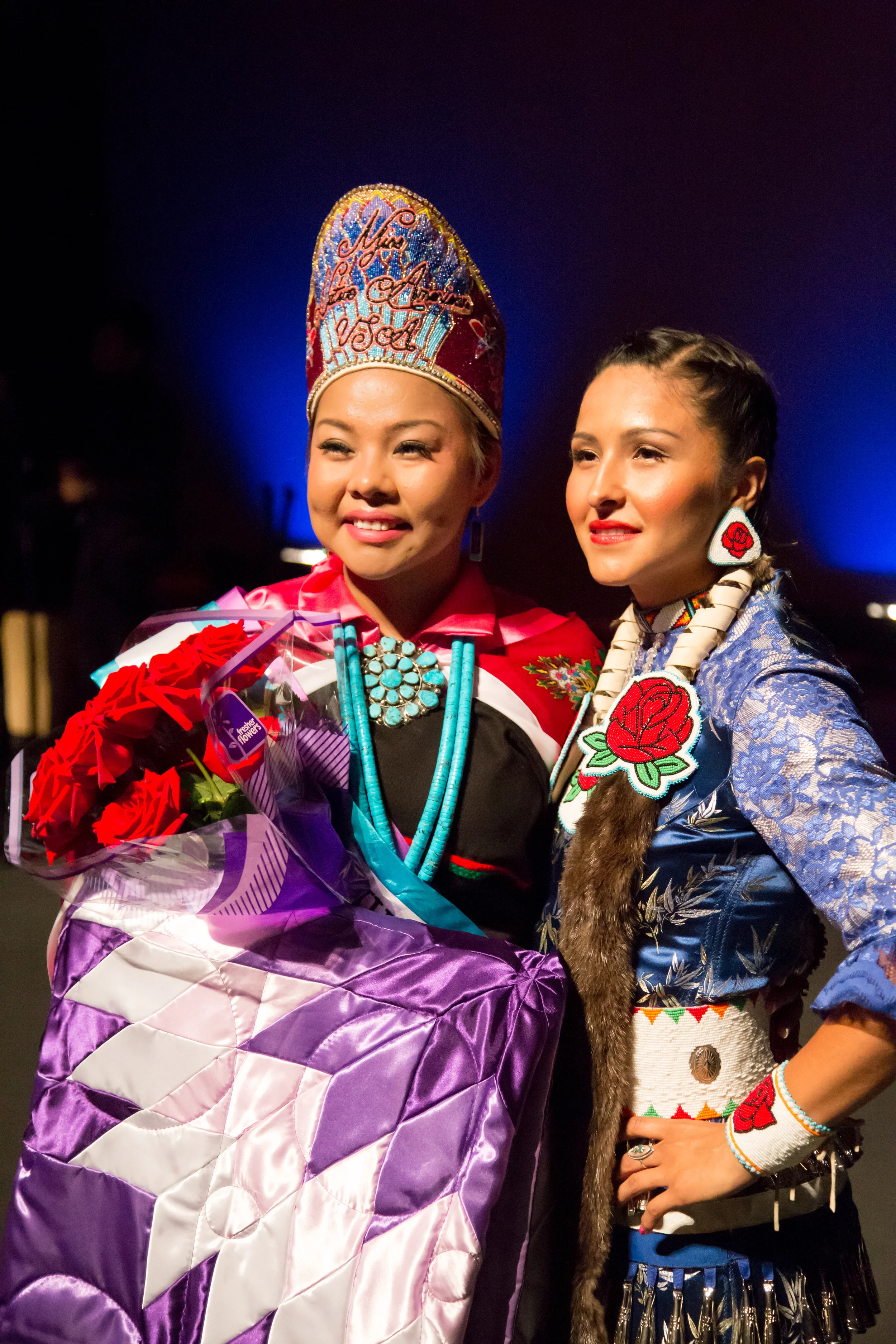 2014-2015 title-holder April Yazza with 2013-2014 title-holder Sarah Ortegon.
