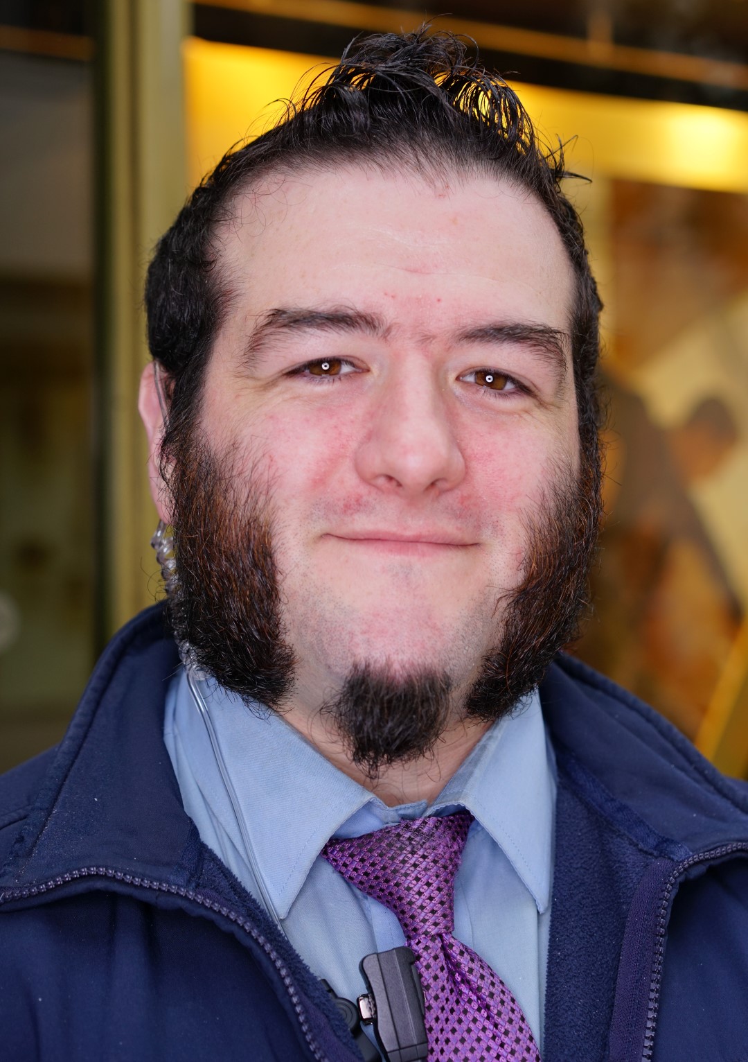 A Security Guard with cool mutton chops, at a dance event in Belfast