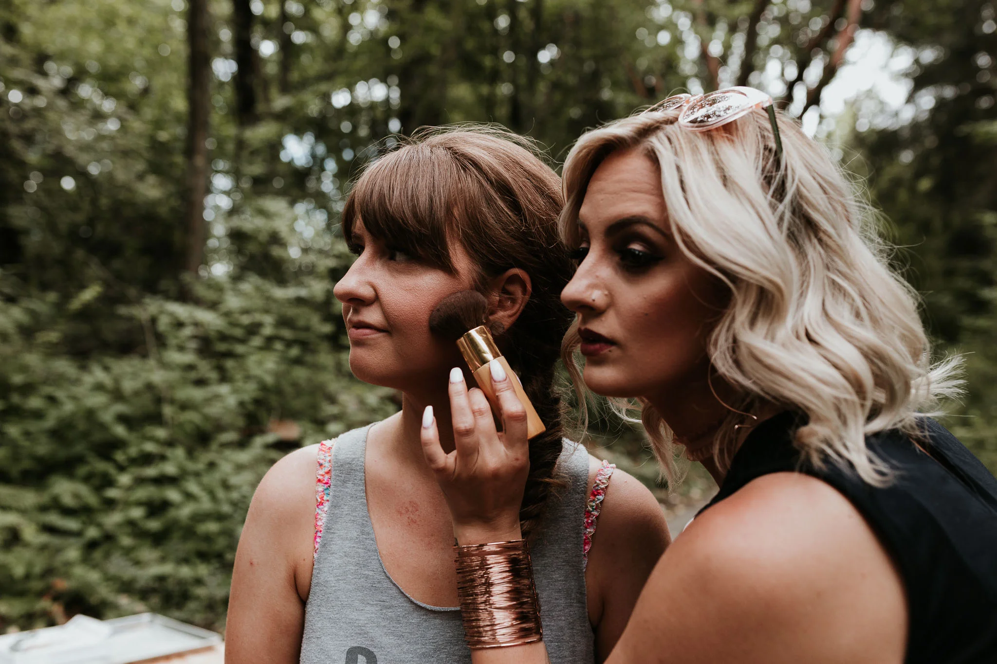 make up artist/best friend double checking the makeup application 