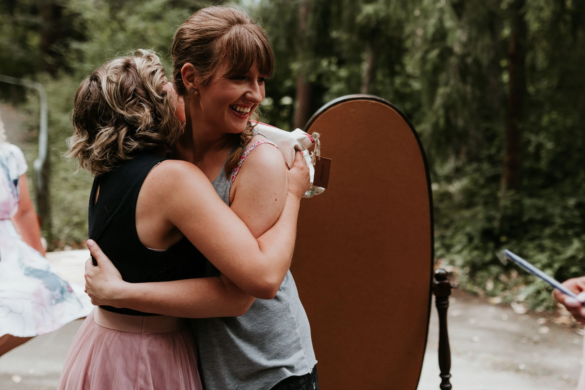 bridesmaid hugging bride as they get ready for the day