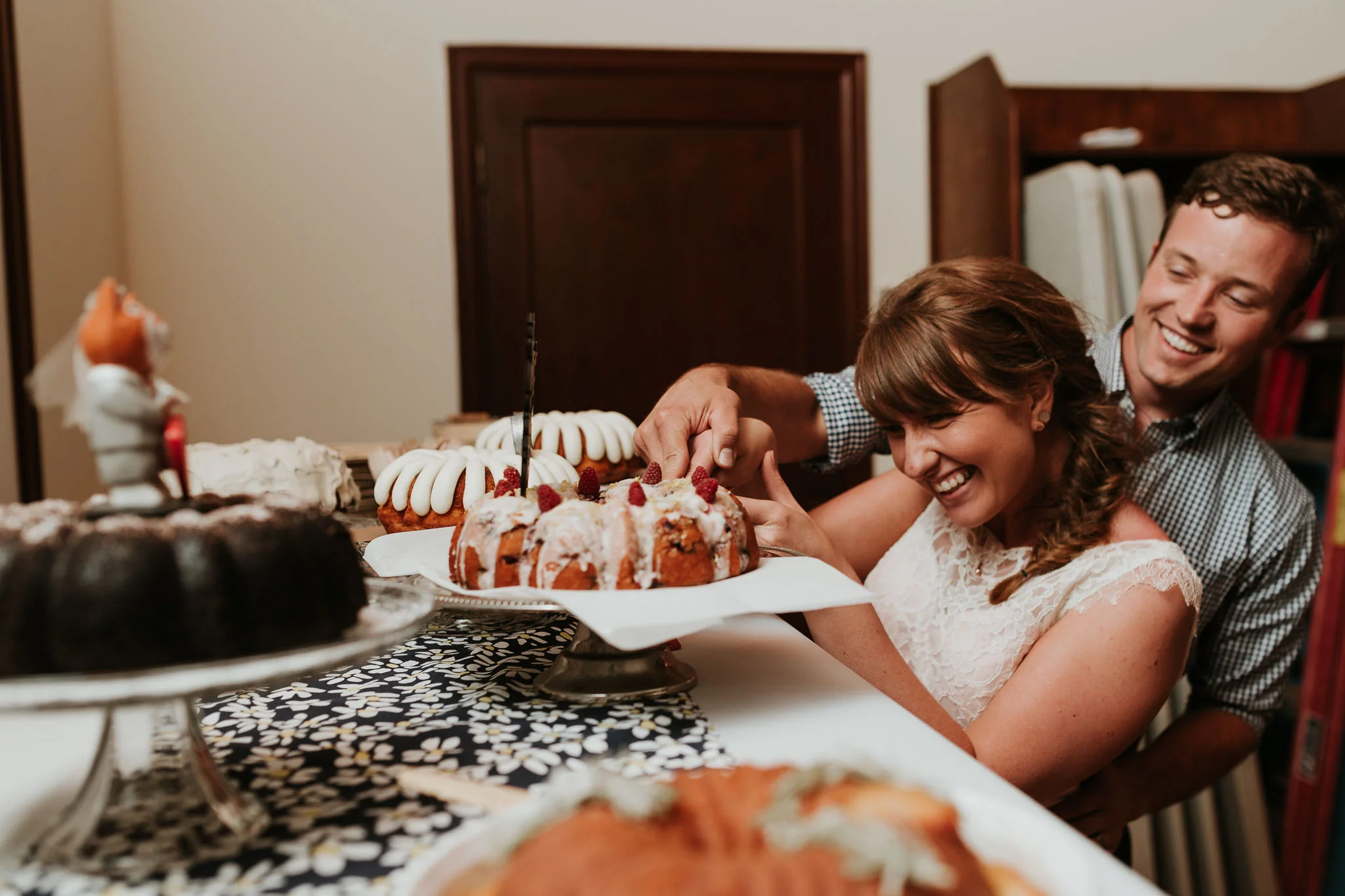bride and groom cutting their non traditional desert 