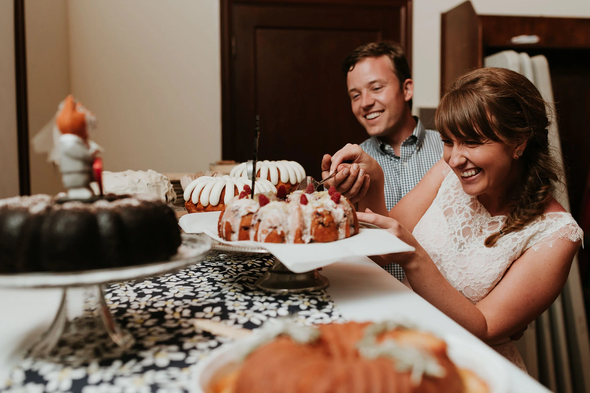 bride and groom cutting their non traditional desert 
