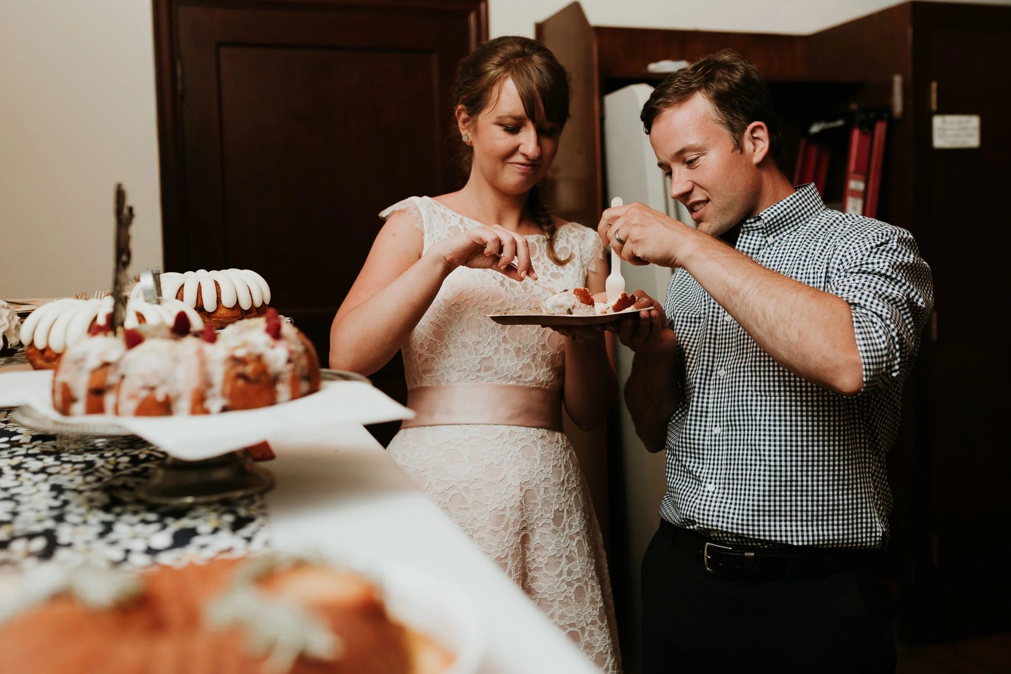 bride and groom cutting their non traditional desert 