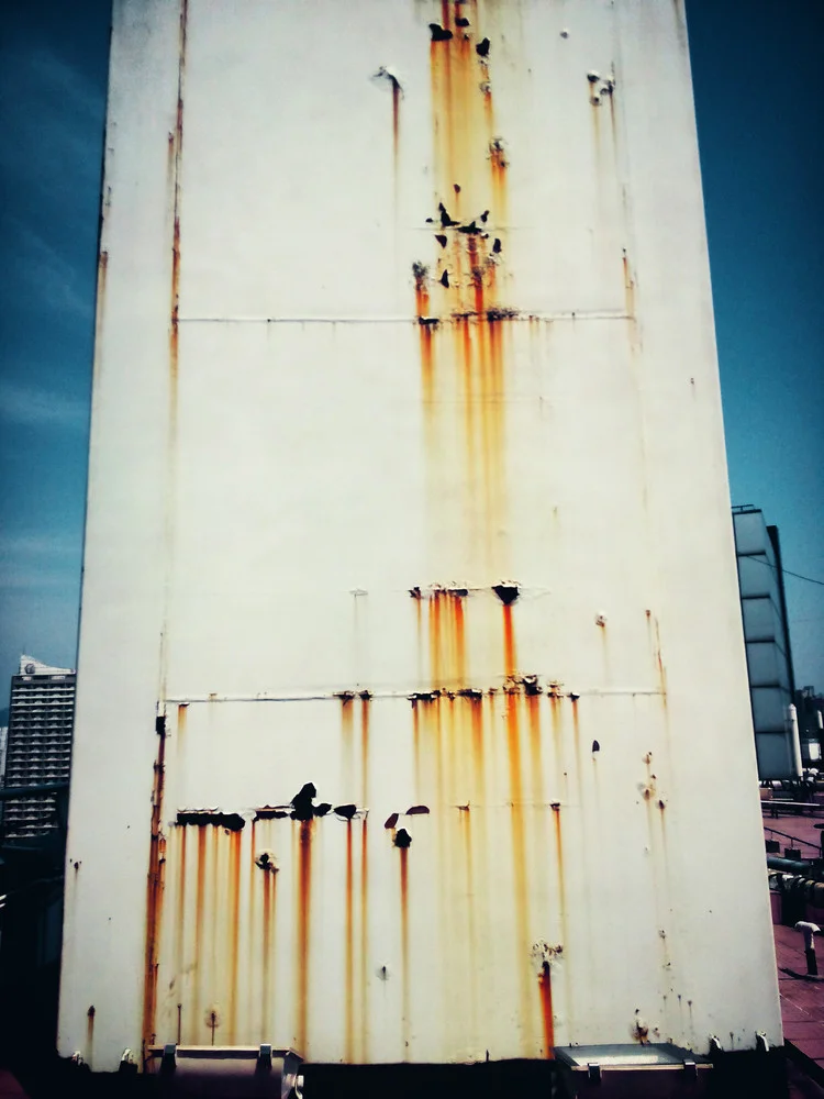 A thick slab of metal weeping rust on the roof of an apartment building. - somewhere near the Suzhou Creek, Shanghai