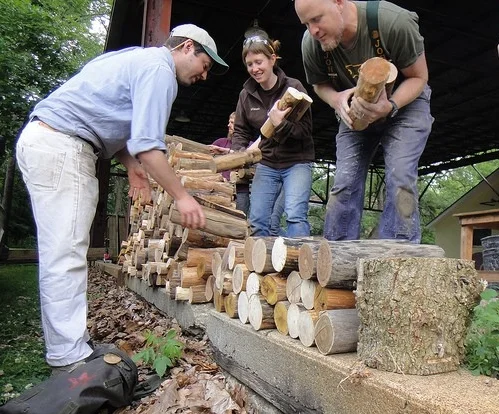 Charles Vinz, Sara Black and Rod Northcutt stacking cordwood for the back wall of the Antioch Tea House (Photo Charles Vinz)