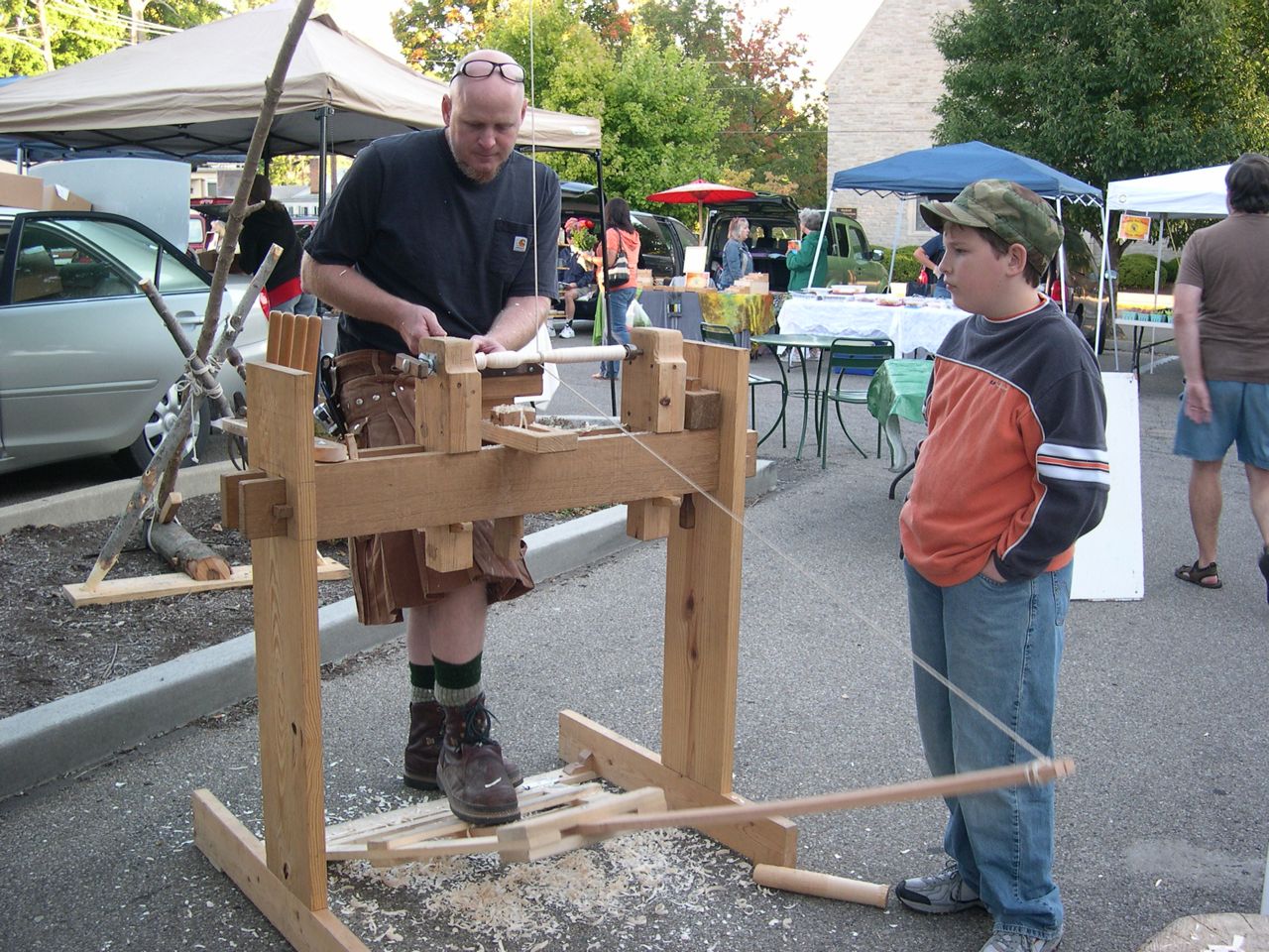 Demonstrating the spring-pole lathe to Eli