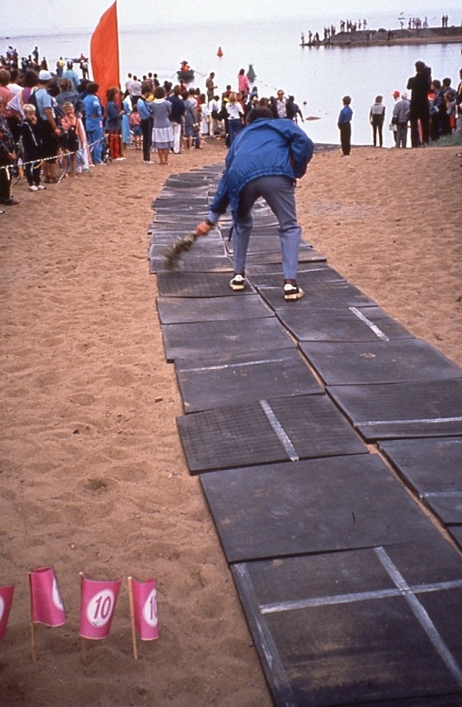 A dedicated crew member sweeps the swimmers' path into the swim, Zelenogorsk, 1990.