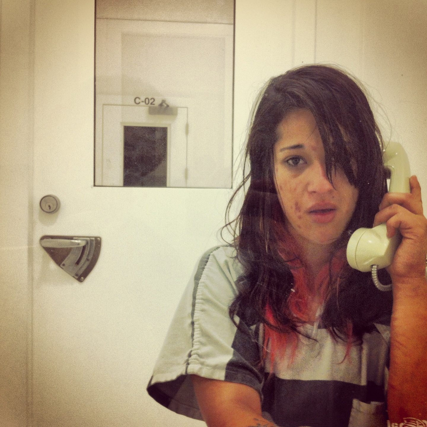 Lisa in an interview room while in jail. She was arrested for prostitution and spent a week in jail, just long enough to suffer through the physical effects of heroin detox. Photo by Tim Matsui.