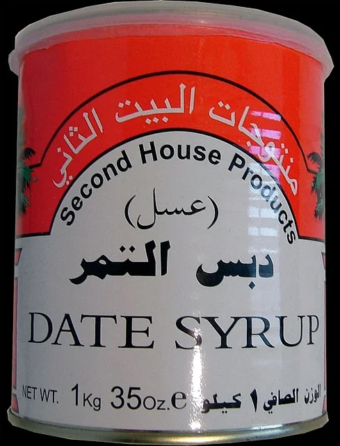 In addition to continuing the gesture of shipping items, I wanted to explore the possibility of importing something that was clearly labeled as Product of Iraq. This venture began with the discovery of a can of Second House Products Date Syrup. Though stamped on the back as Product of Lebanon, the date syrup is in fact processed in Baghdad, put into large plastic vats, and then driven over the border into Syria, where it gets packed into unmarked aluminum cans. It is then driven across the border into Lebanon where it receives a label and is then exported to the rest of the world. From 1990 until May 2003, this was one method that Iraqi companies used in order to circumvent UN sanctions. It was still in practice in August 2004, more than one year after the sanctions had been dropped, due to prohibitive “security” charges levied by U.S. Customs and Border Patrol and Homeland Security for any freight bearing the origin of Iraq. The date syrup led me to dates, which were legendary in Iraq, with a yield of over 600 varieties. I signed a deal with an Iraqi company, Al Farez, to import one ton of dates from the city of Hilla, the first such deal in more than 25 years.