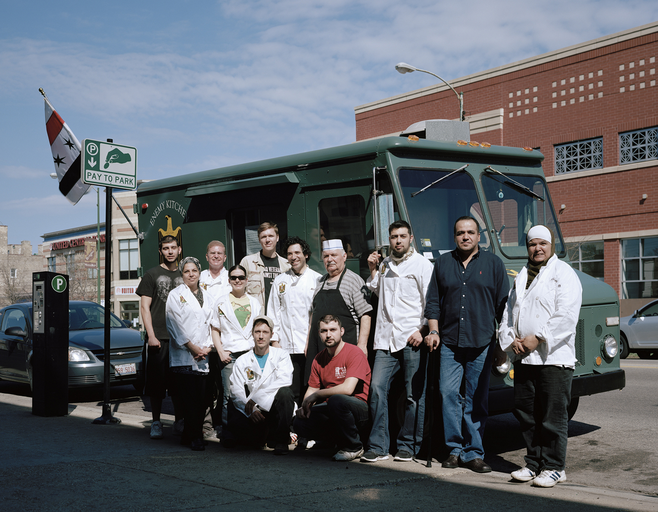   Enemy Kitchen staff, comprised of Iraqi refugees and American veterans of the Iraq War, outside of Milo’s Pita Place, an Iraqi restaurant in Chicago's Rogers Park neighborhood that operates the truck. Most Iraqi restaurants in the city call themsel