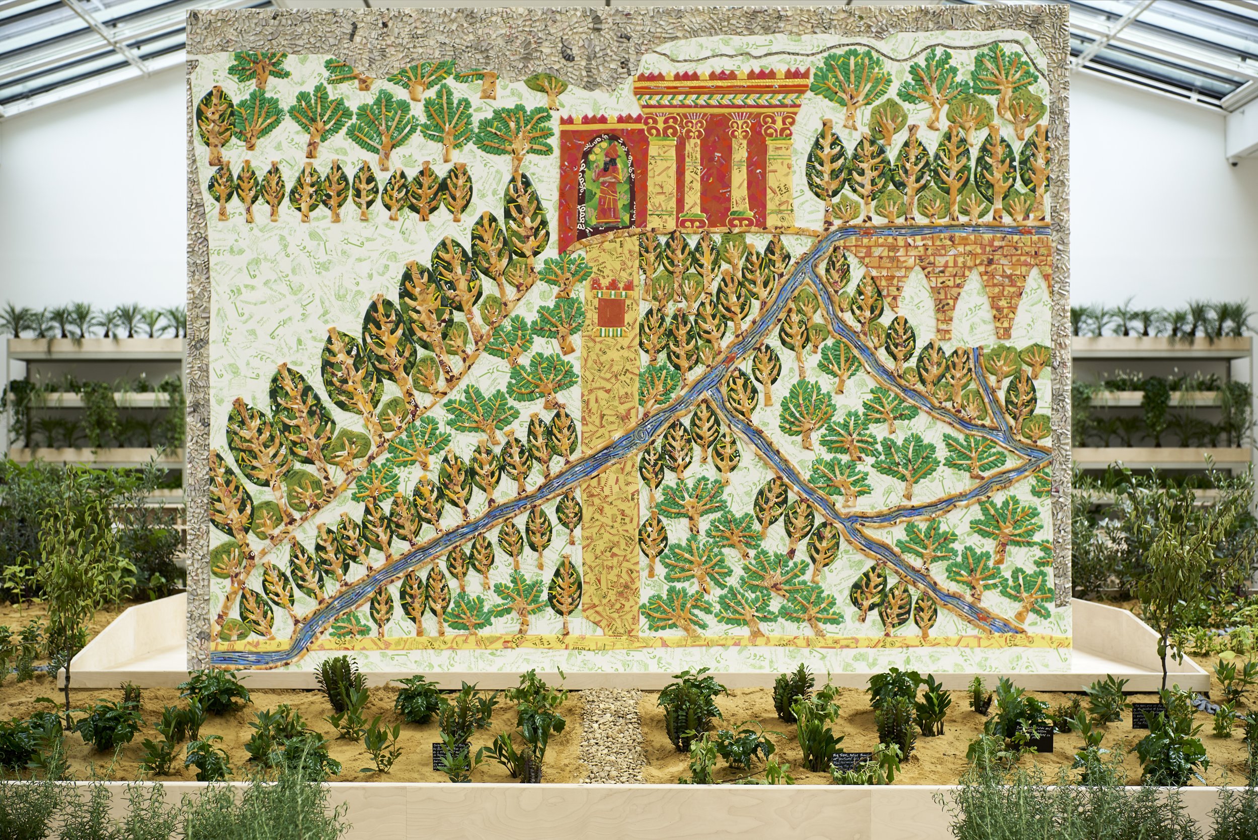 The colors on the panel are those that archaeologists believe were used on the original stone panel. The architectural footprint of the North Palace of Nineveh is recreated in the layout of the garden beds, shelves, and workstations behind the panel,