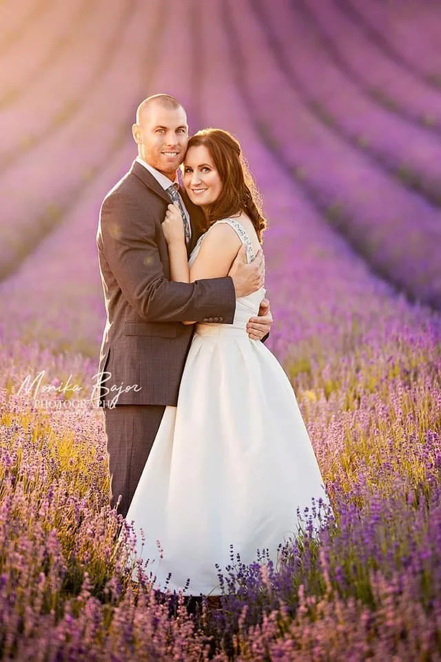 Bride and groom sharing a quiet moment on their wedding day surrounded by lavender.