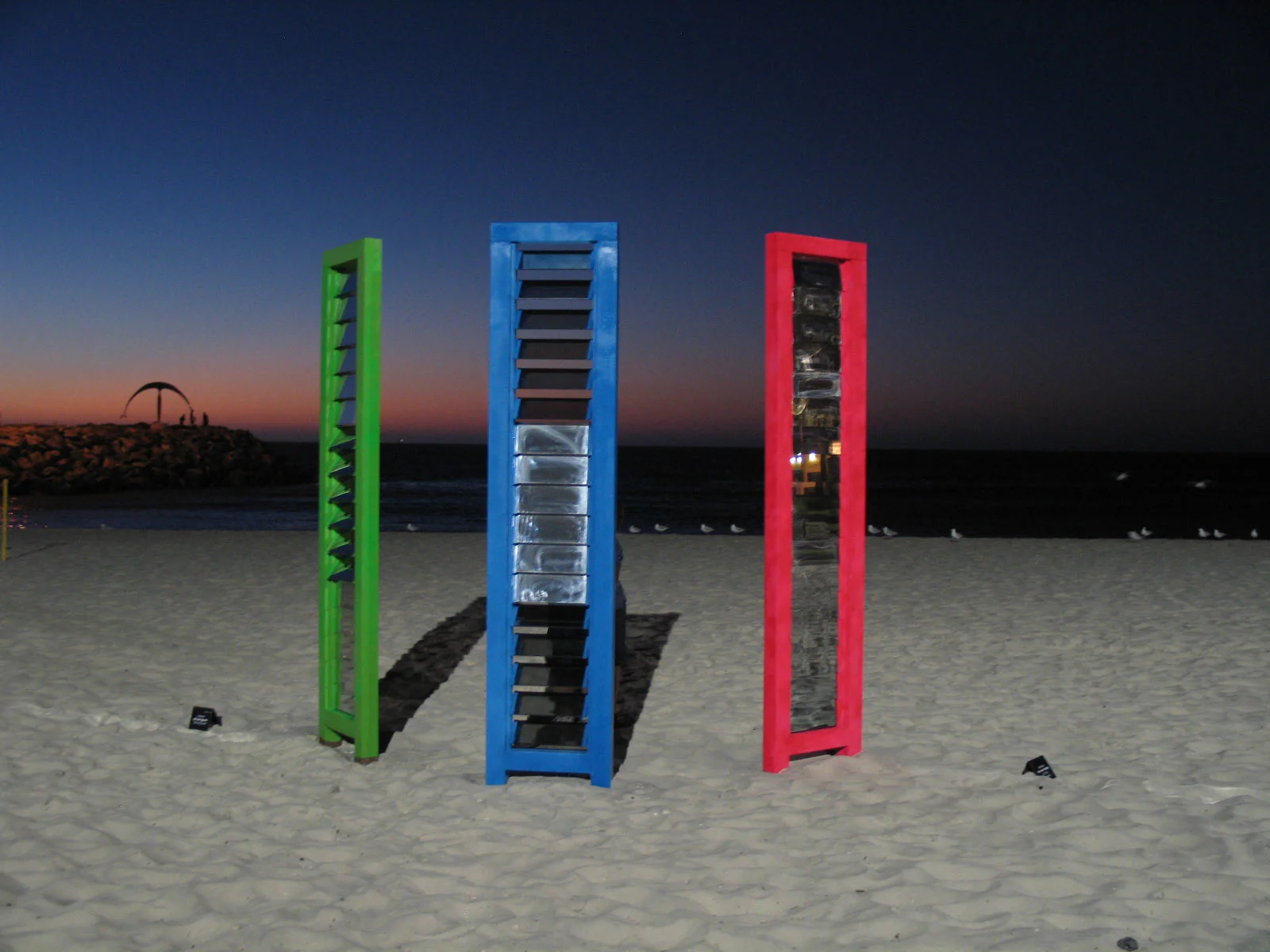 Kaleidoscope, 3 towers each 300 c 65 x 15 cm, total footprint 6 m x 3 m , wood, mirrastar double sided semitransparent mirror glass, pvc. Sculptures by the Sea 2010