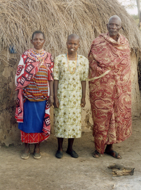  In front of one of the thatched mud huts of the family boma. Each wife has a separate hut. 