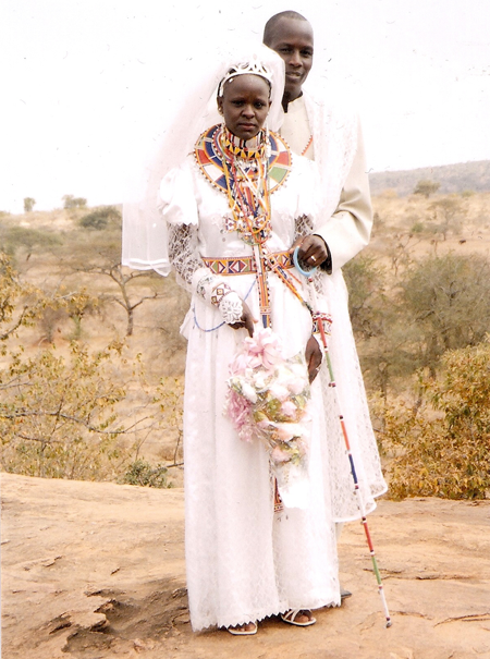  Florence and her husband, Henry, on their wedding day in 2009, Isinya. Along with her beautiful wedding dress, she is adorned with traditional Maasai beaded jewelry. 