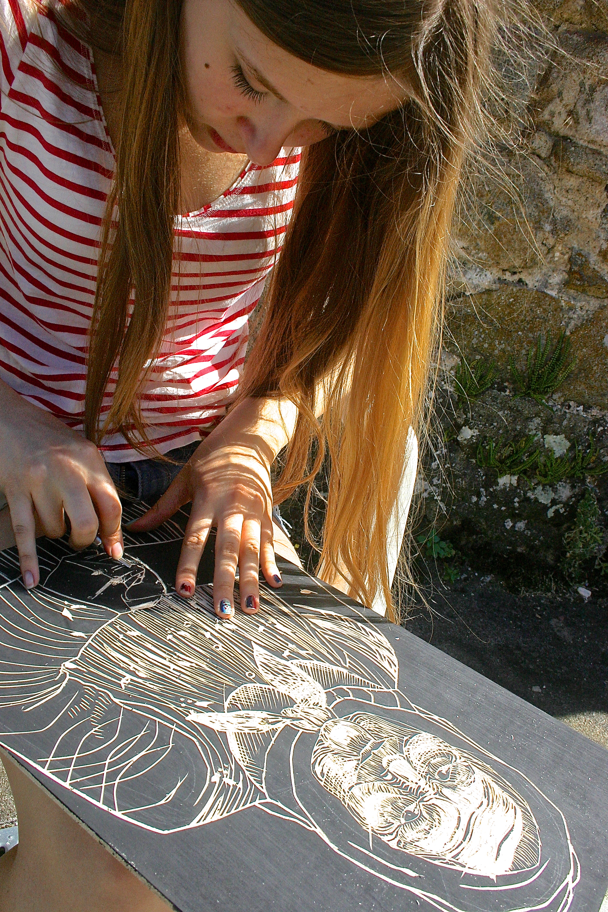 a printmaking student working on a wood block print at les tapies 