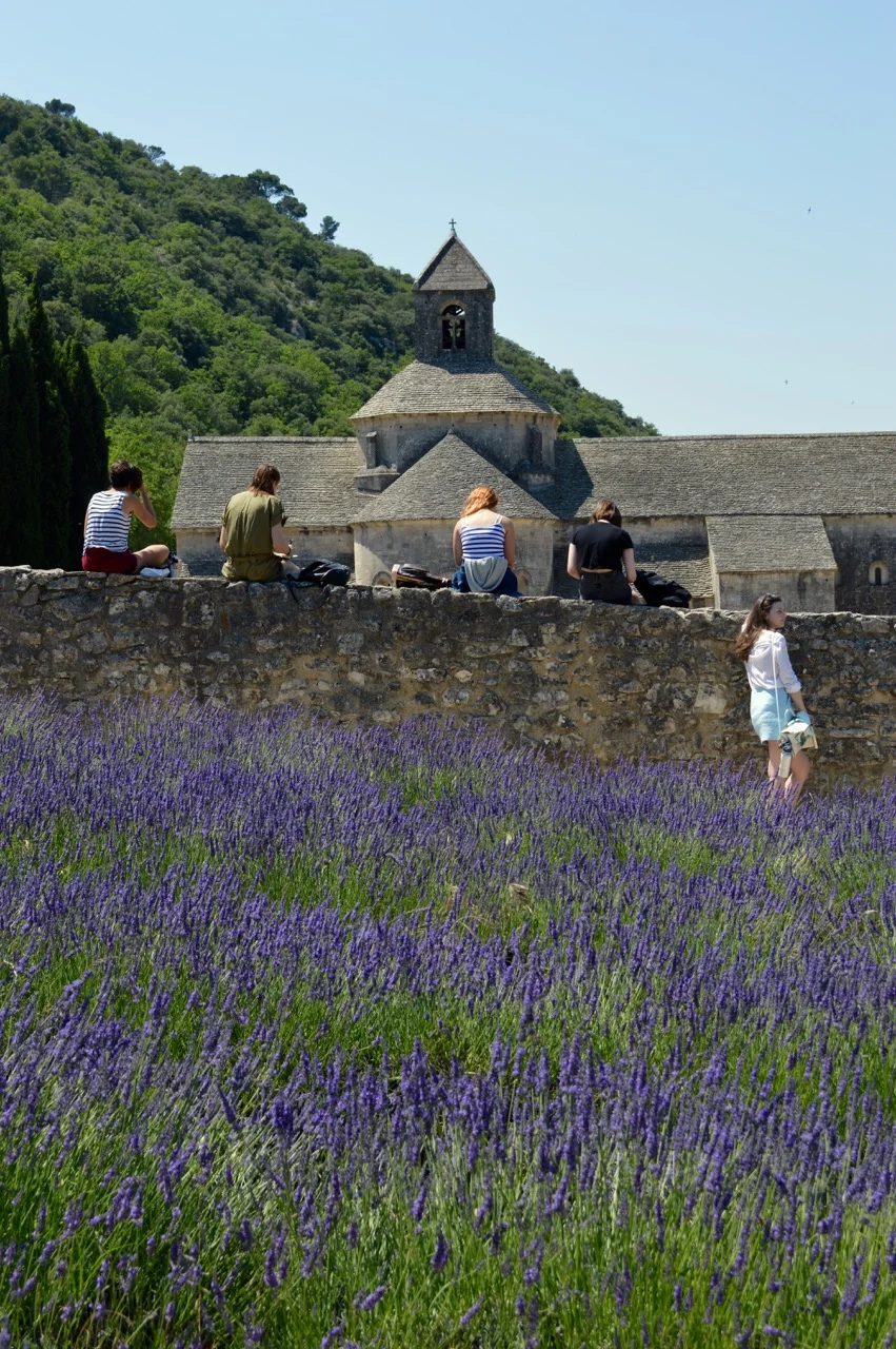 Les Tapies students sit to draw the abbey