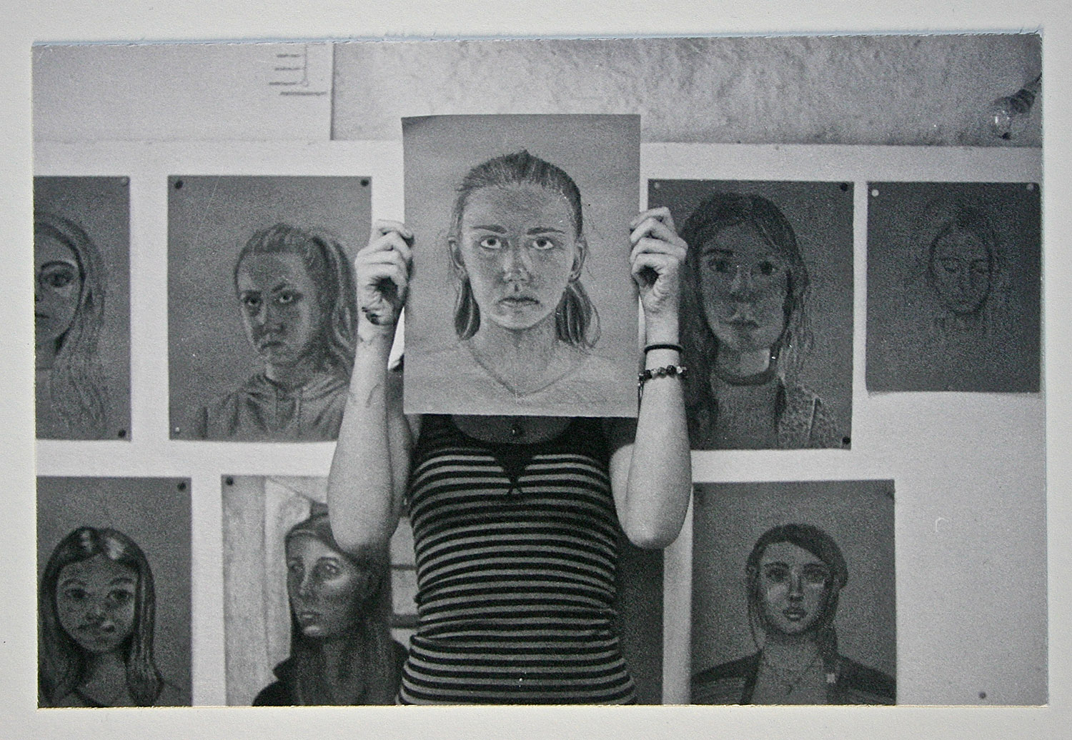  a student with her self portrait drawing&nbsp; 