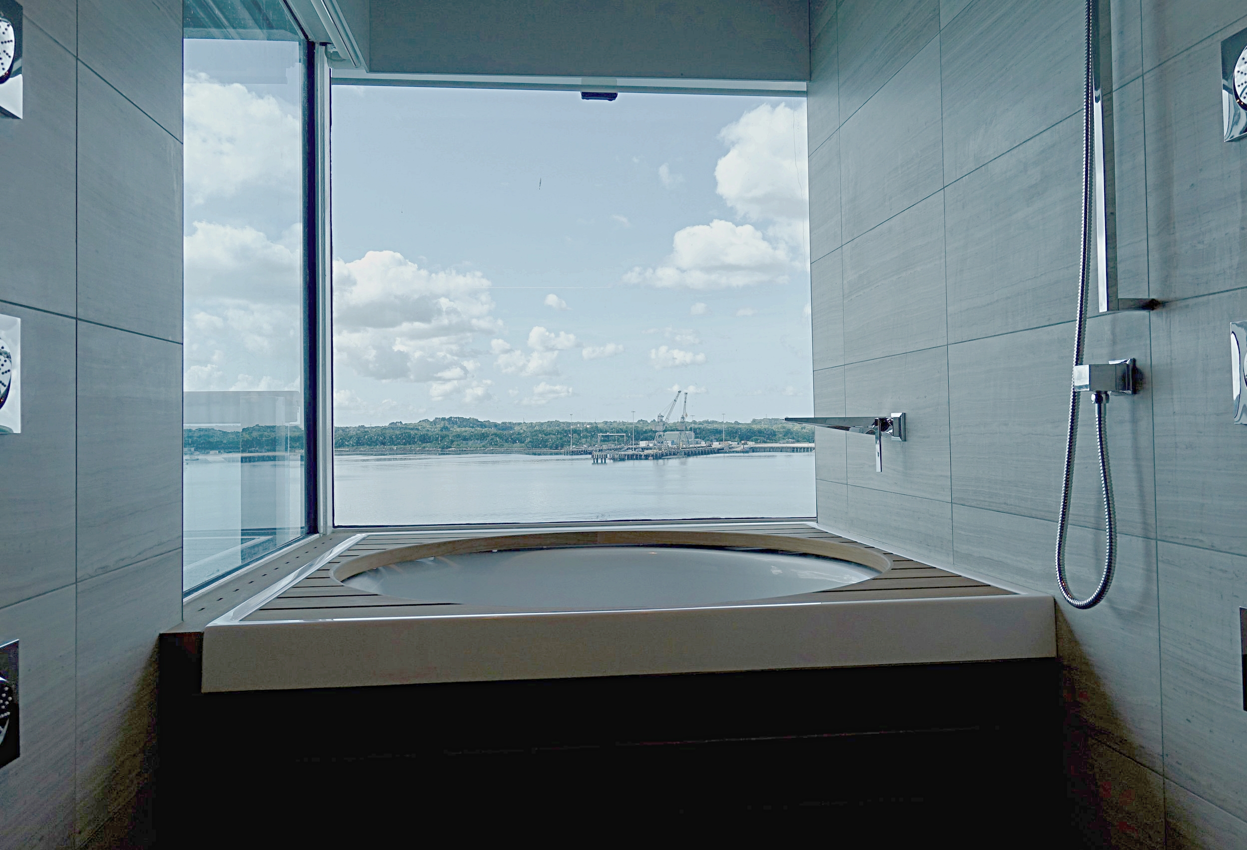 The amazing circular bath and multi-directional shower area set with a glass enclave in the Club Spa Suites.